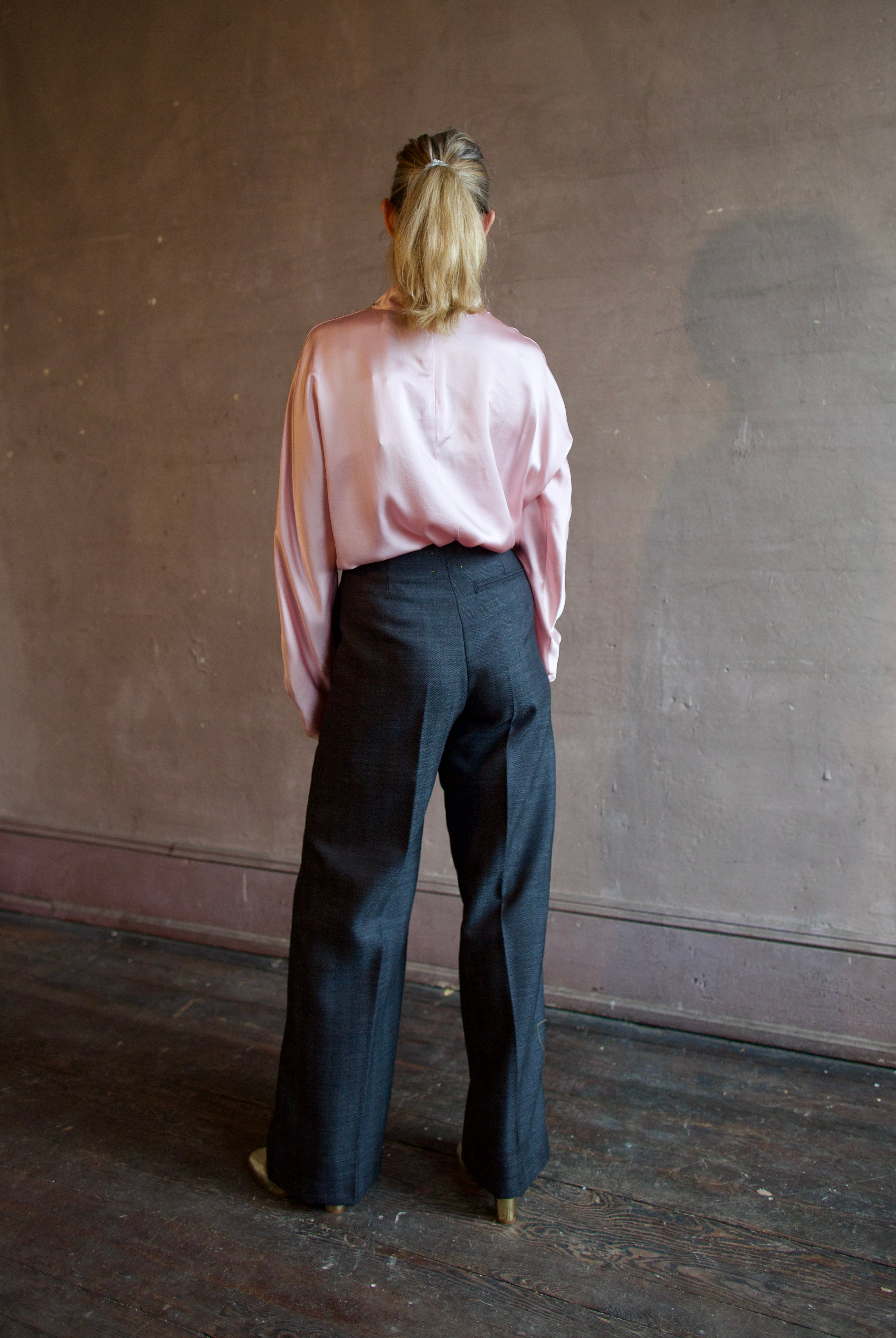 Image featuring a woman wearing herringbone pants by Forte Forte with a mid rise, straight leg and beaded embellishment along one side.
