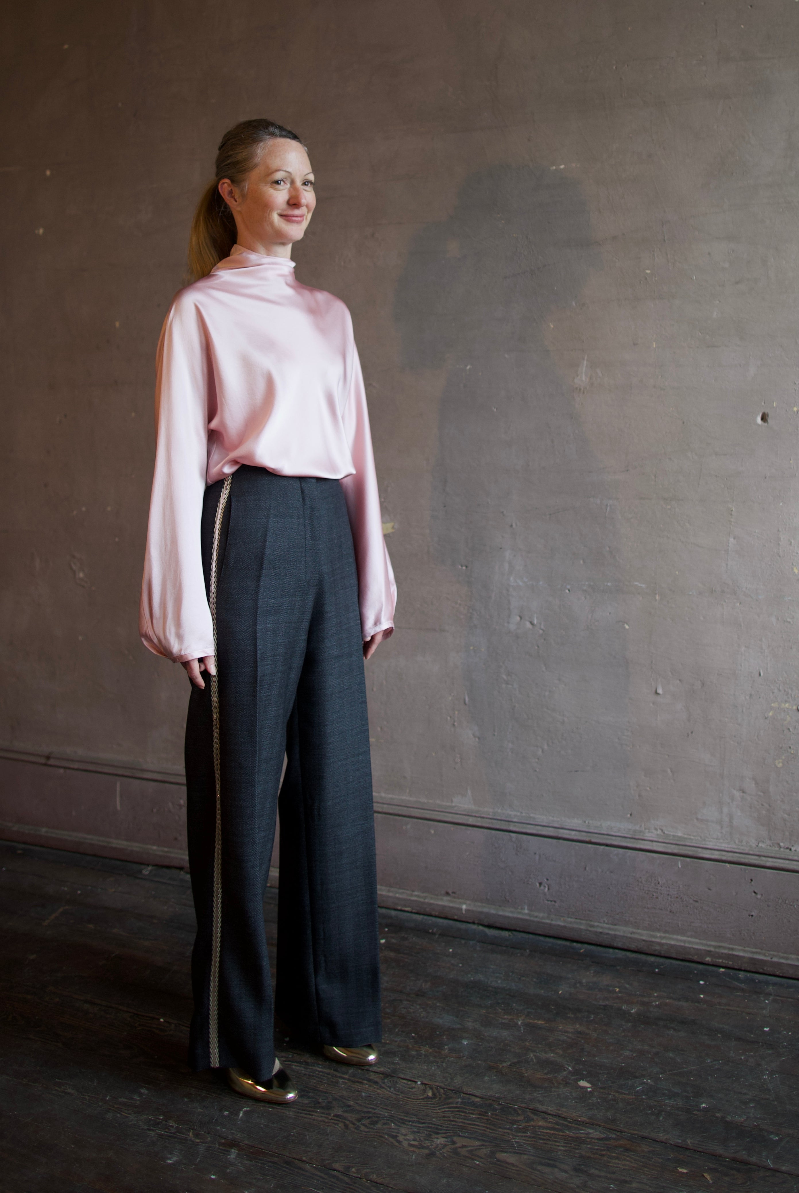 Image featuring a woman wearing herringbone pants by Forte Forte with a mid rise, straight leg and beaded embellishment along one side.
