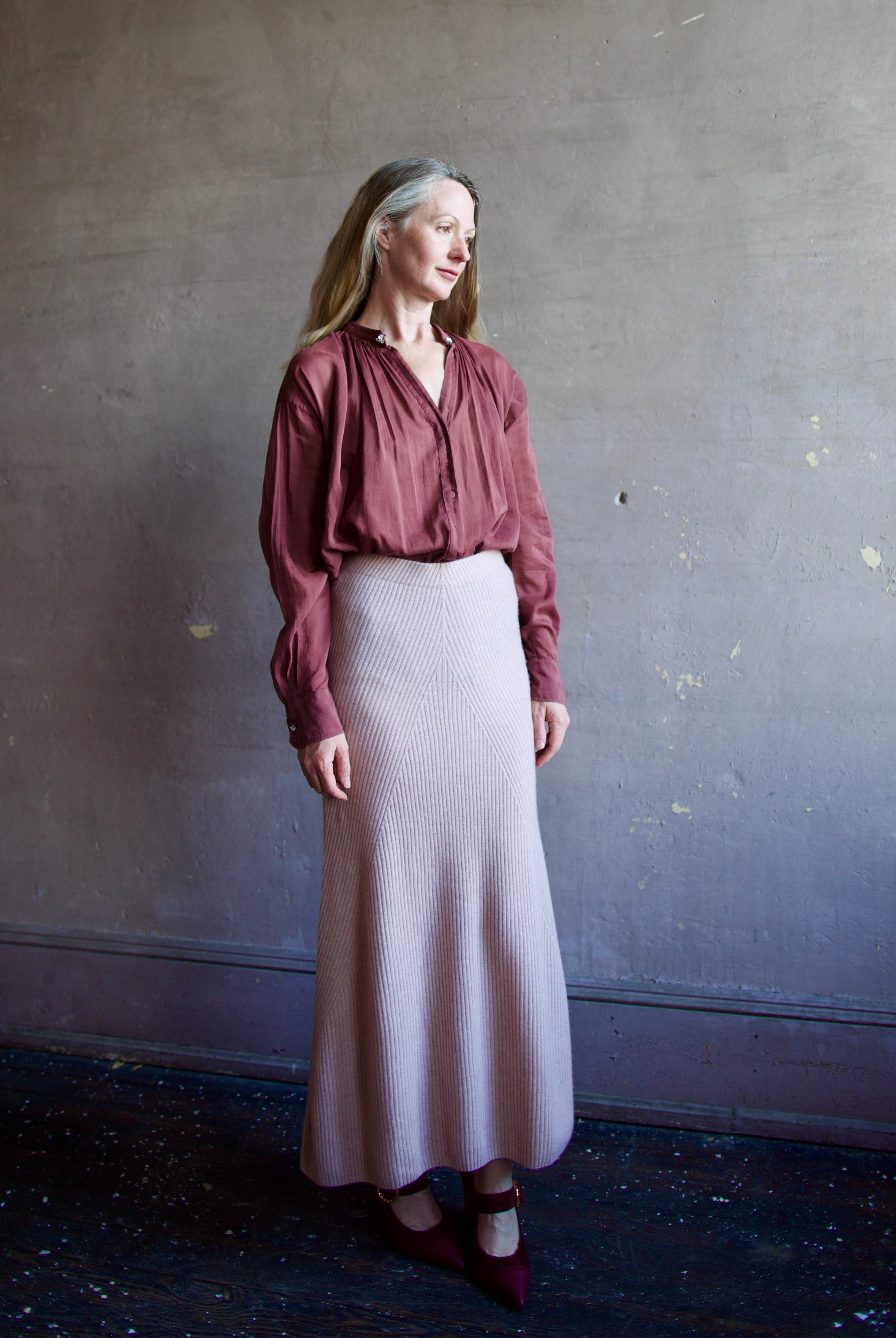 Image featuring a woman wearing the voile bohemian shirt by Forte Forte with a hook and eye closure and crystal embellishment at neckline and long sleeve button.