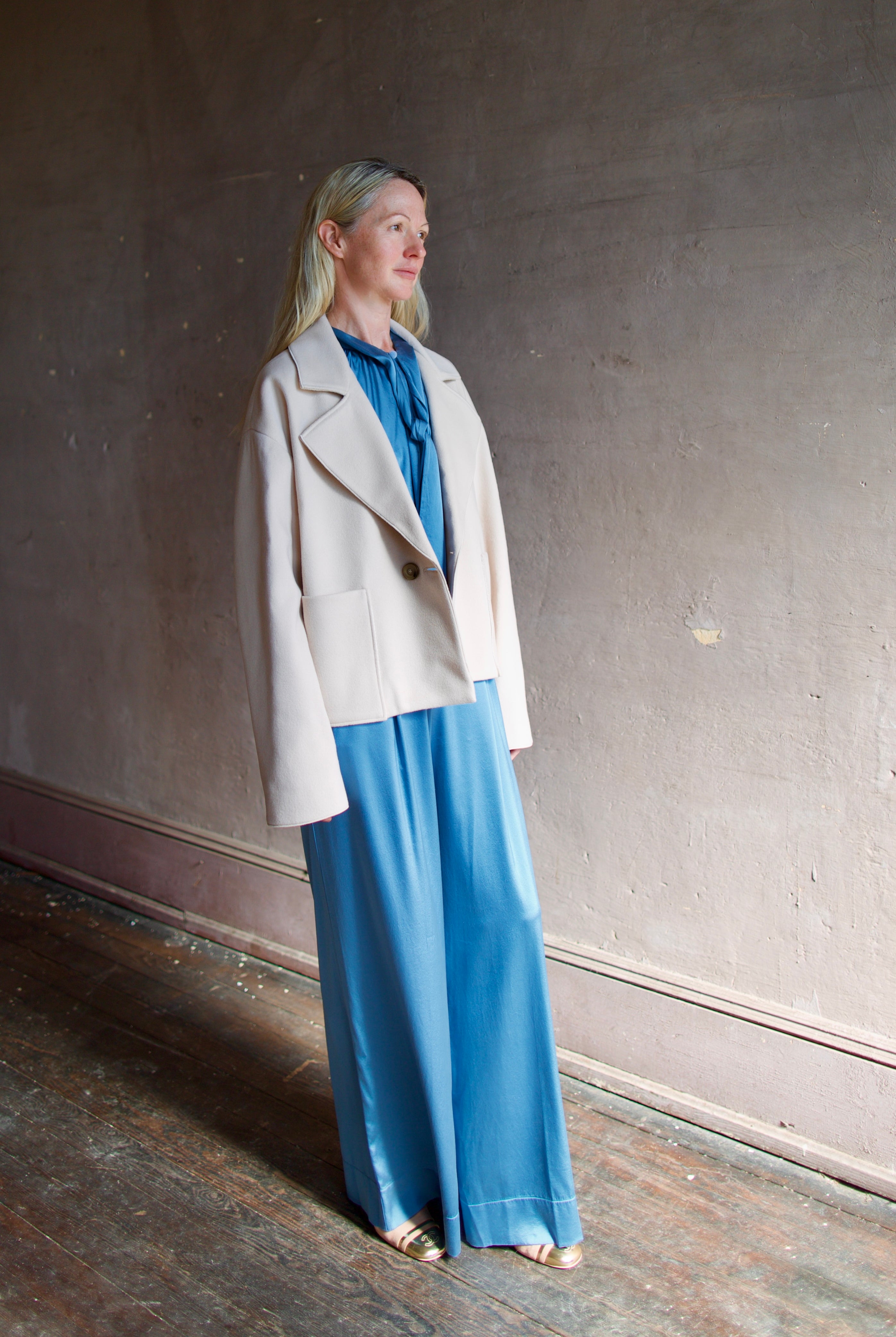 Model wearing expertly tailored Forte Forte beige jacket in premium virgin wool and cashmere with front pockets and button closure