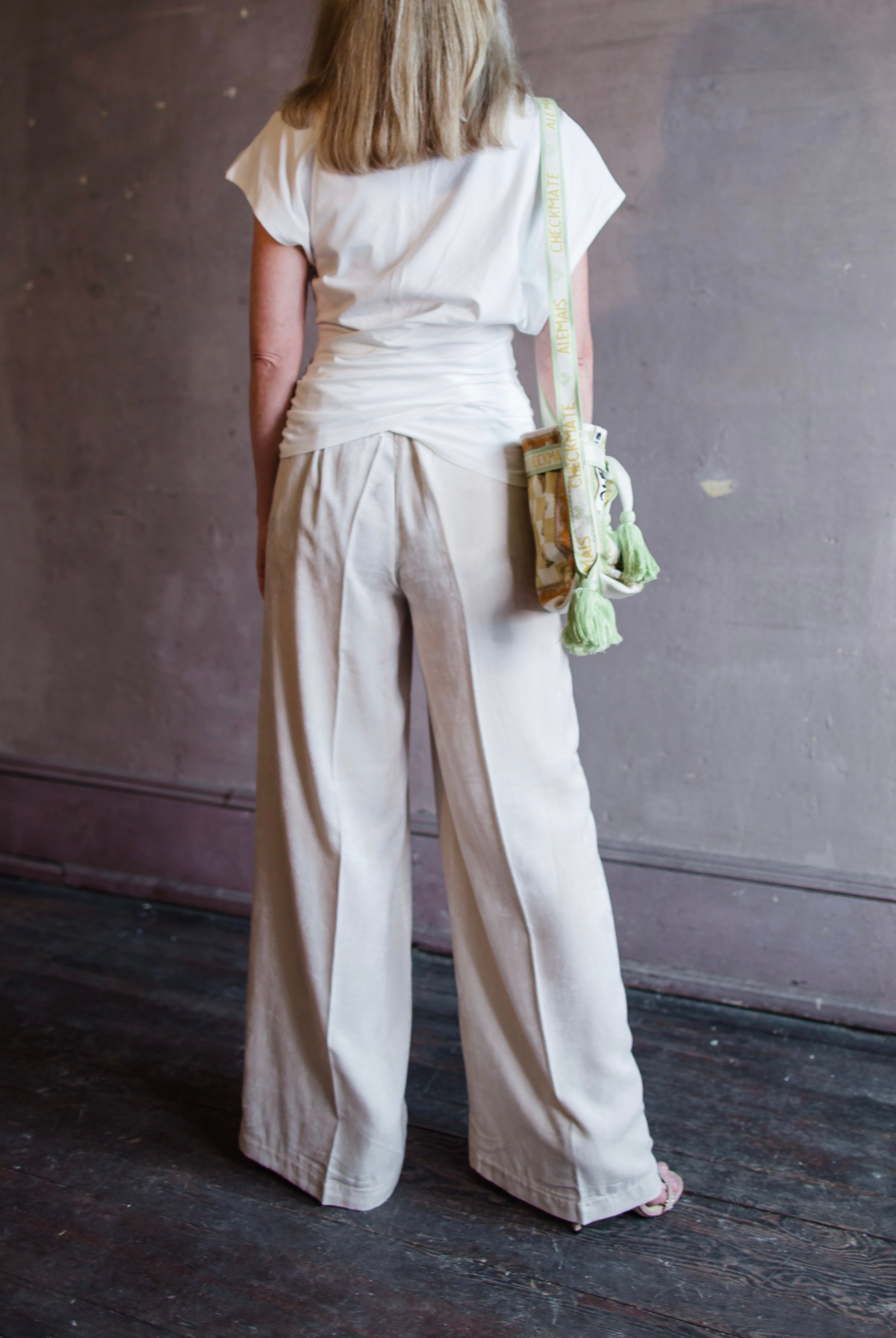 Image featuring a woman wearing the matte corduroy pants by Forte Forte with an elastic waist and flowy wide leg in ivory.