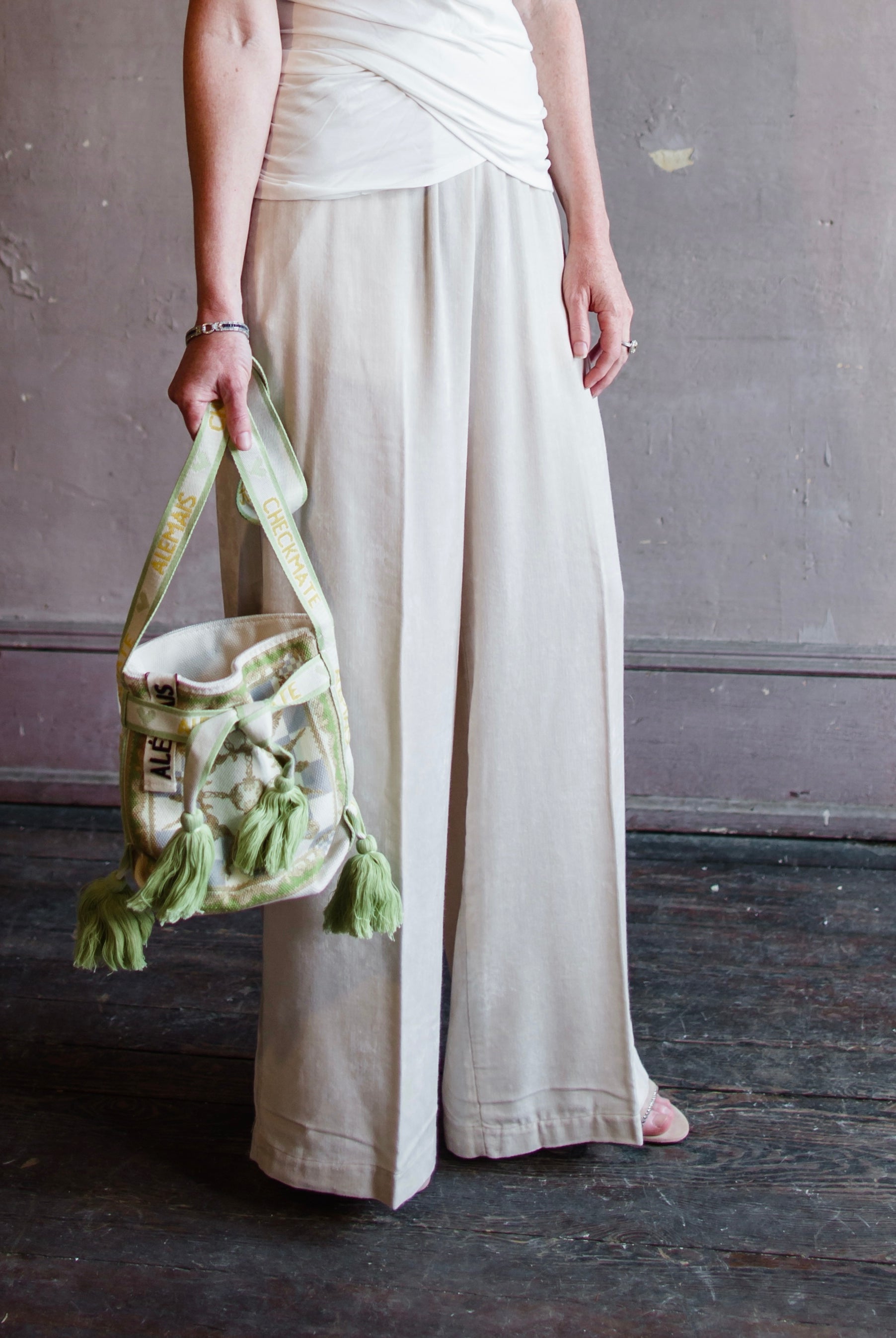 Image featuring a woman wearing the matte corduroy pants by Forte Forte with an elastic waist and flowy wide leg in ivory.
