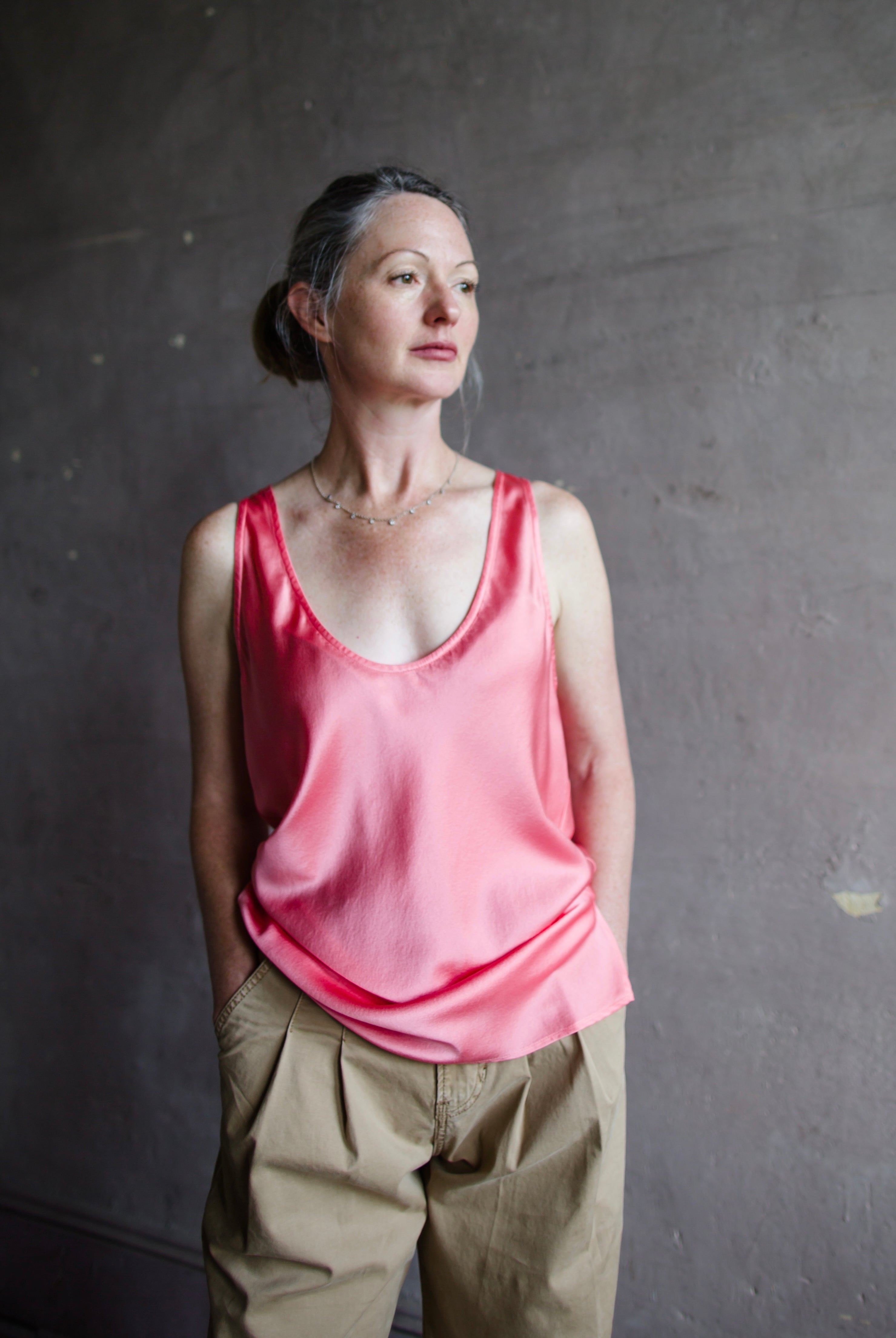 Image featuring a woman wearing the pink heavy satin silk tank by Forte Forte with a scoop neckline and relaxed fit.