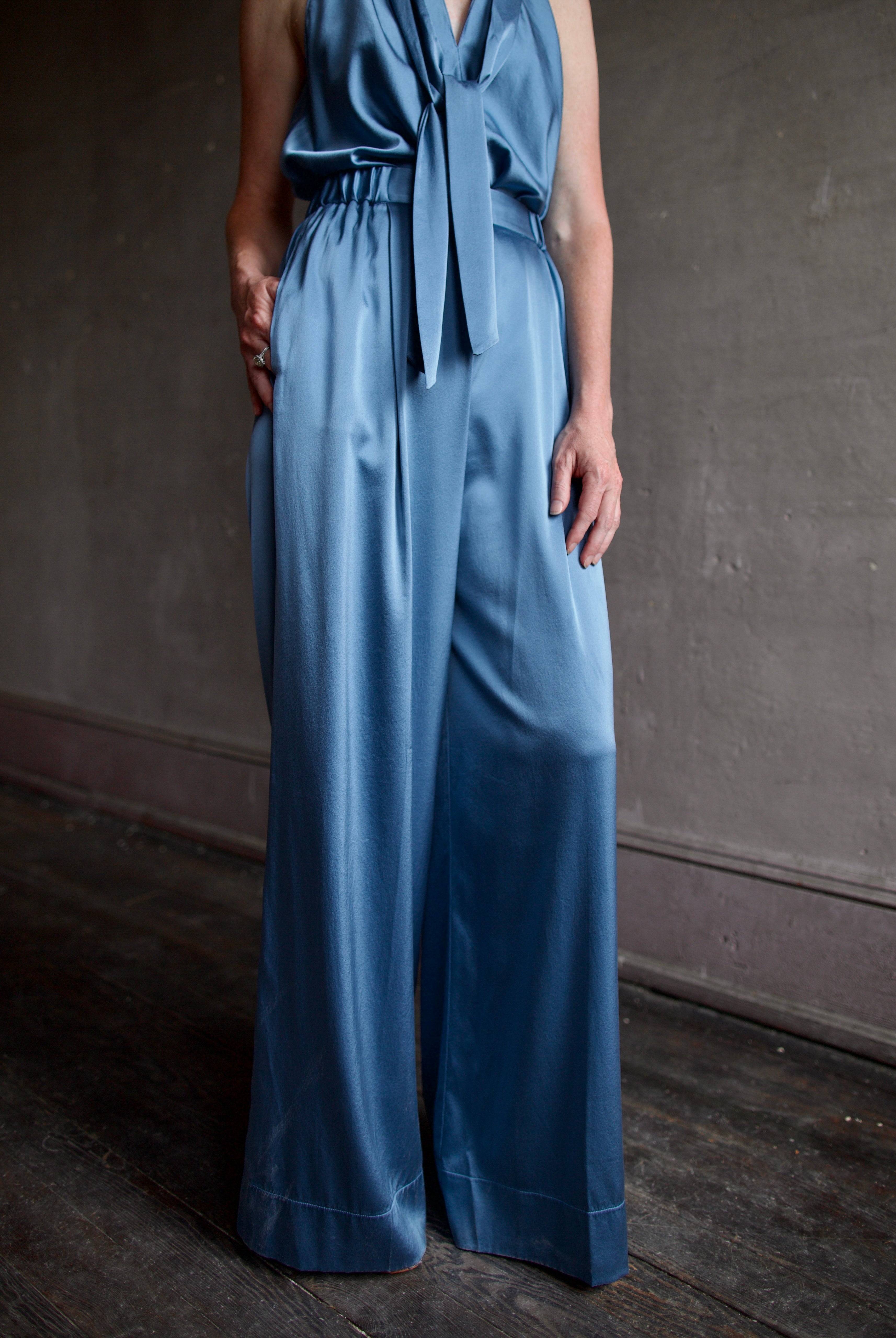 Mature model wearing luxury women's clothing Italian designer Forte Forte blue silk top and pant set