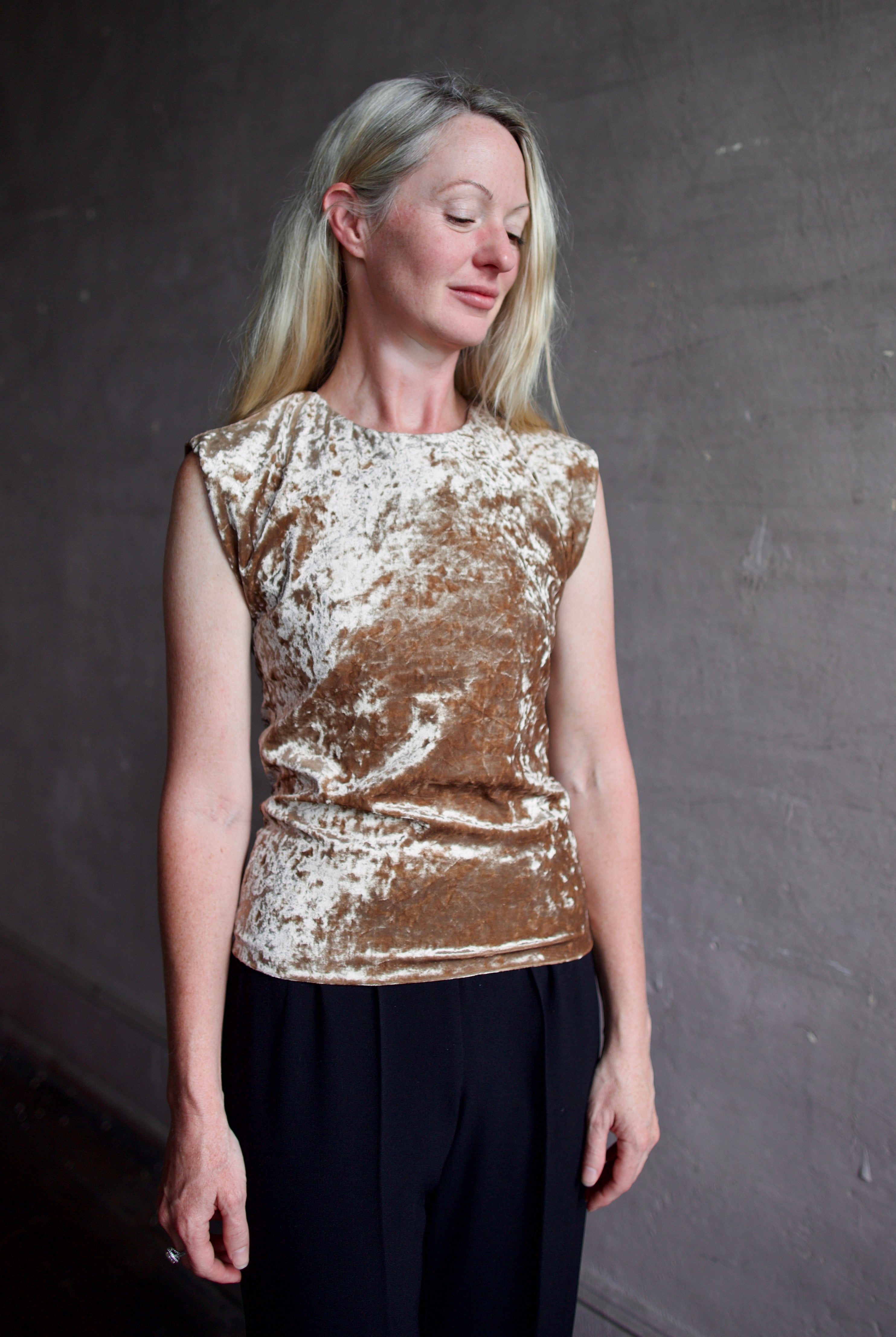 Mature model wearing sleeveless velvet top paired with timeless tuxedo stripe trousers from high-end Italian designer Forte_Forte