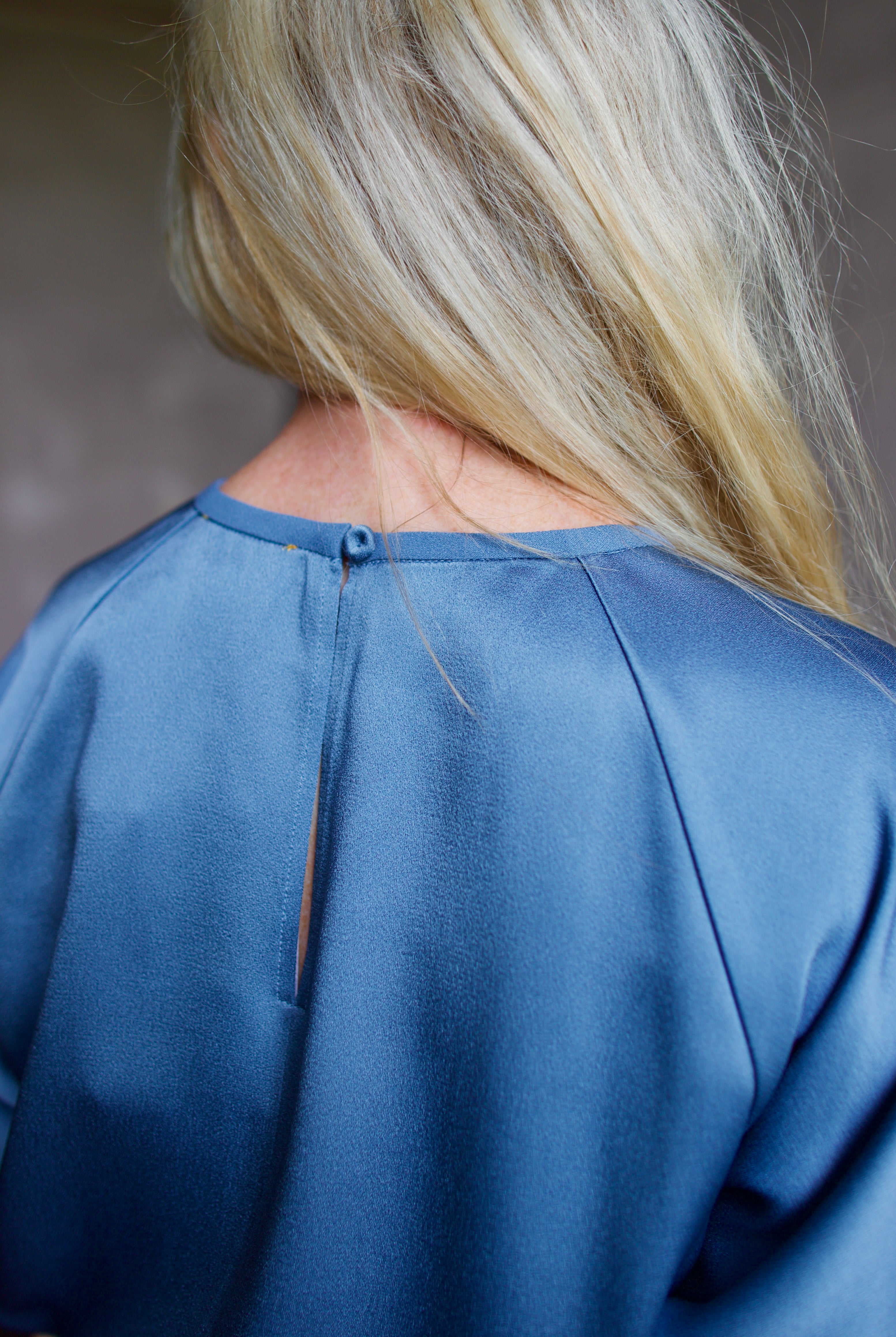 Close up showing back details of high-end Italian fashion designer Forte Forte short sleeve blue blouse