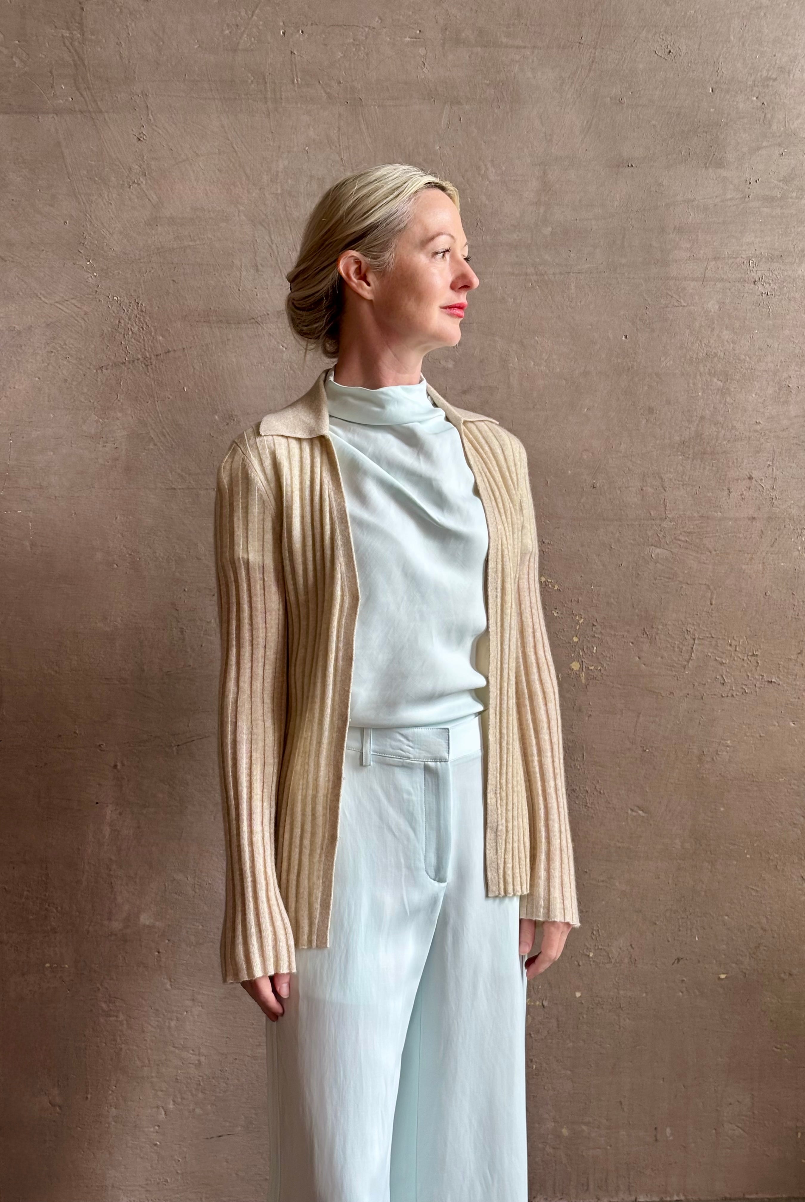 Image of mature woman wearing premium cashmere linen GUEST IN RESIDENCE Breezy Cardigan in Sandstone beige with long sleeves hook and eye front closure and ribbed texture