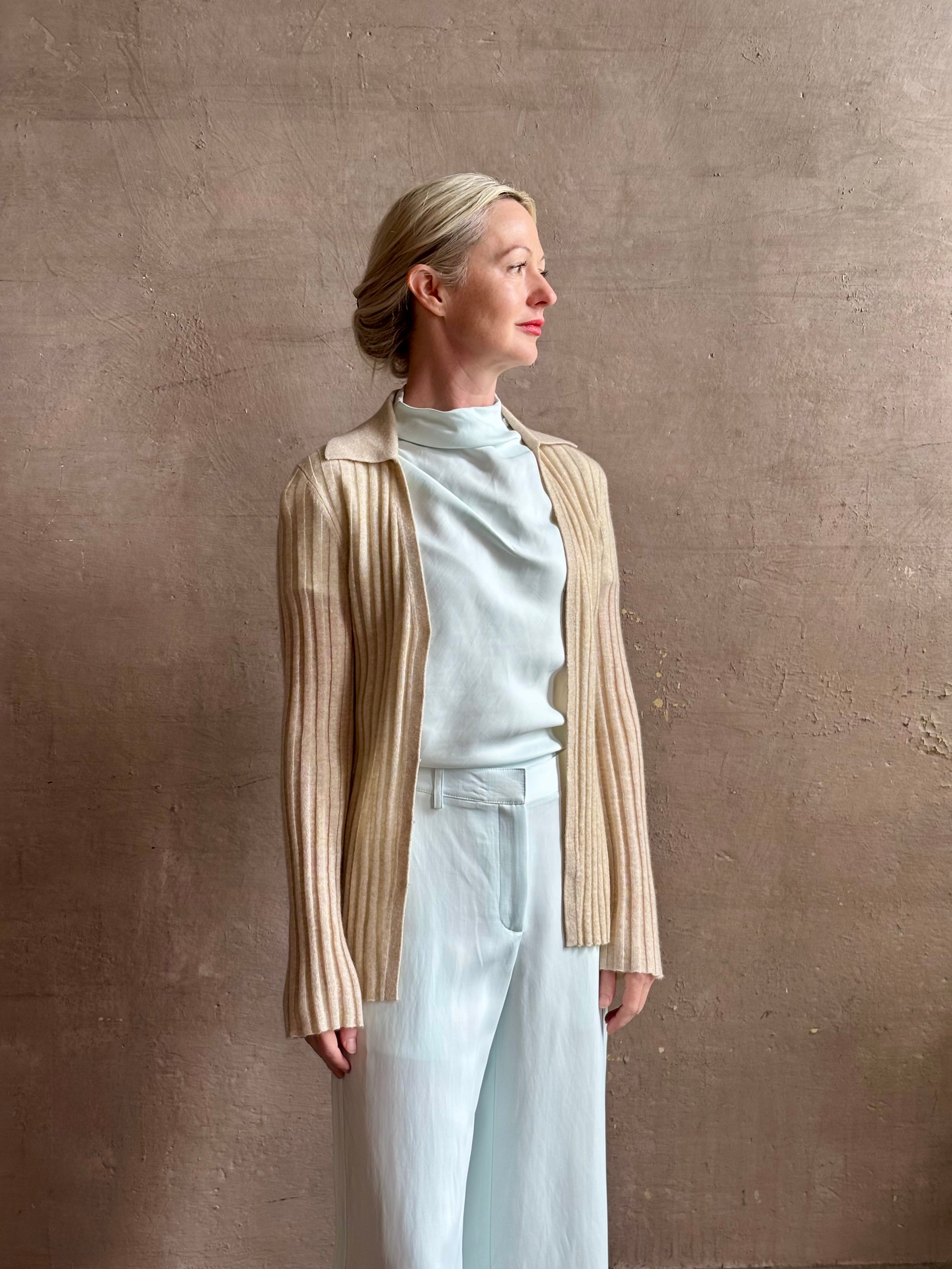Image of mature woman wearing premium cashmere linen GUEST IN RESIDENCE Breezy Cardigan in Sandstone beige with long sleeves hook and eye front closure and ribbed texture