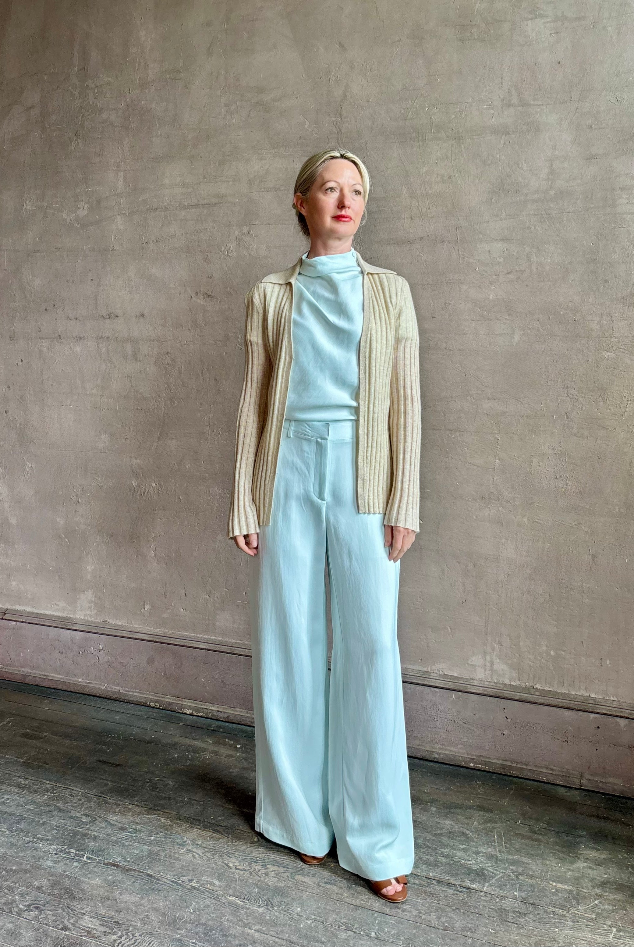 Image of mature woman wearing premium cashmere linen GUEST IN RESIDENCE Breezy Cardigan in Sandstone beige with long sleeves hook and eye front closure and ribbed texture