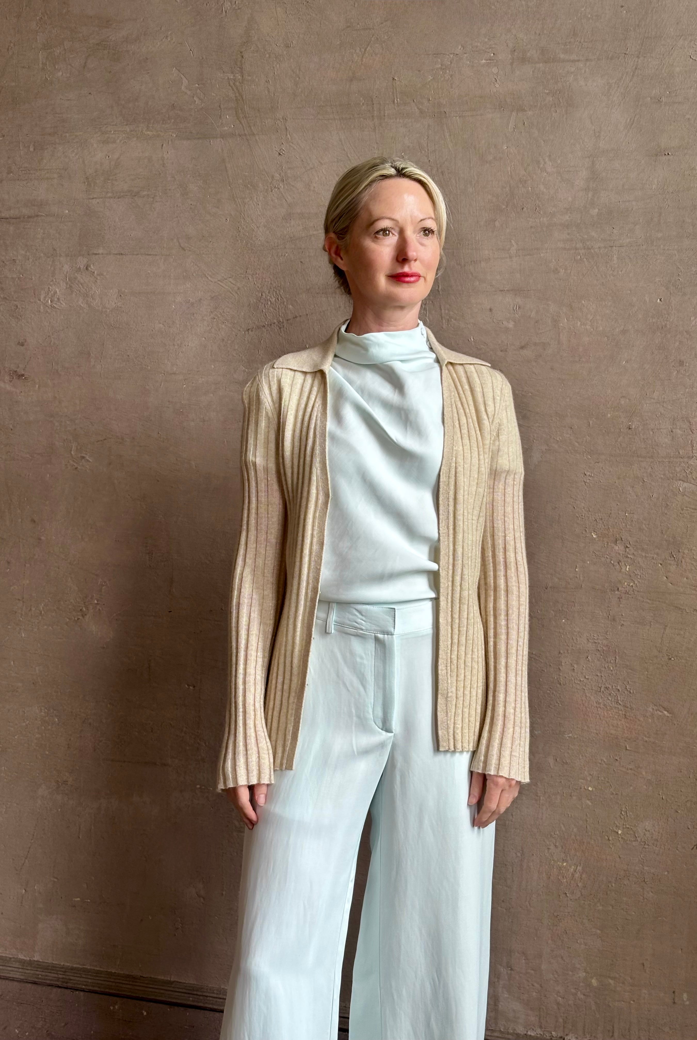 Image of mature woman wearing premium cashmere linen GUEST IN RESIDENCE Breezy Cardigan in Sandstone beige with long sleeves hook and eye front closure and ribbed texture