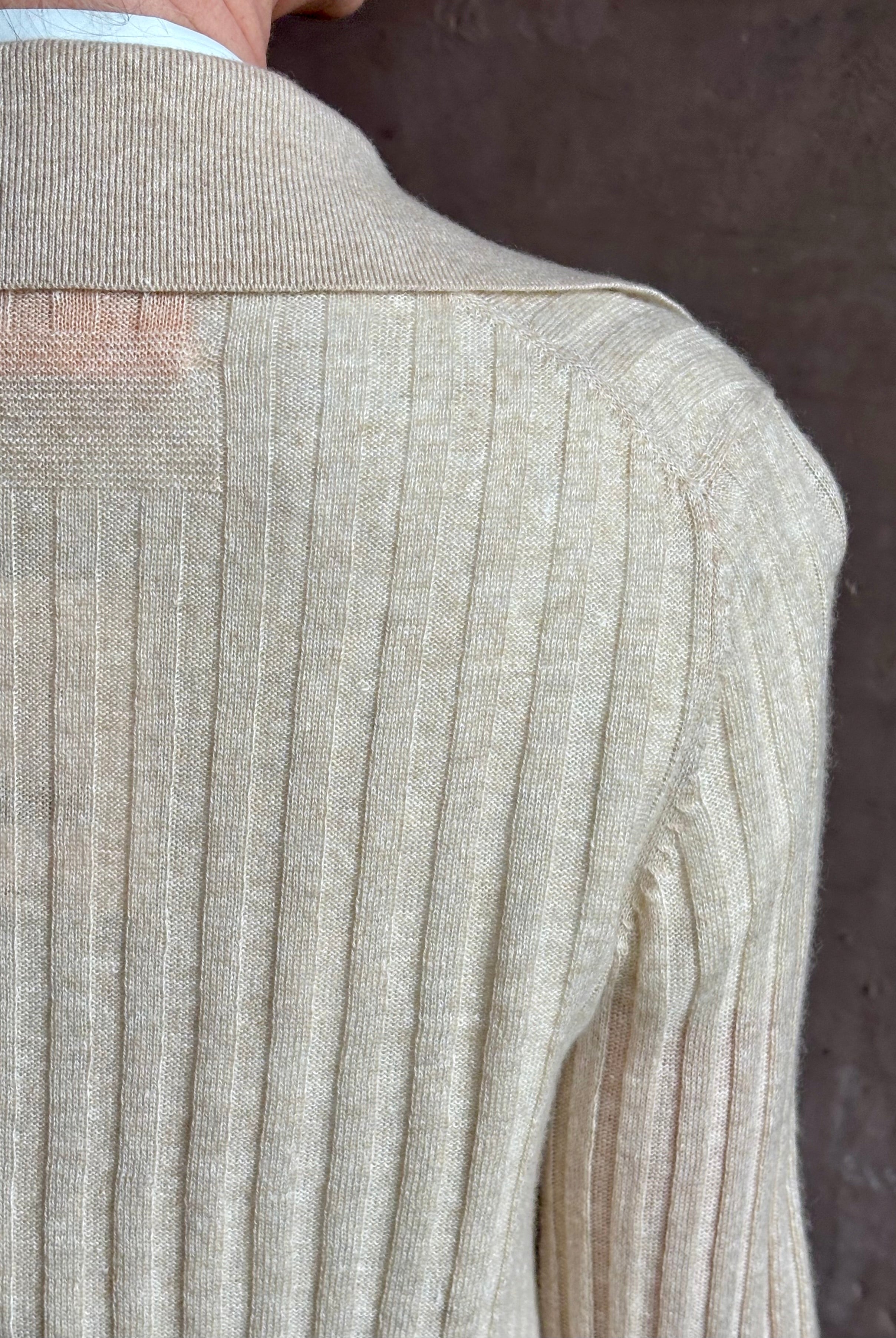 Image of mature woman wearing premium cashmere linen GUEST IN RESIDENCE Breezy Cardigan in Sandstone beige with long sleeves hook and eye front closure and ribbed texture
