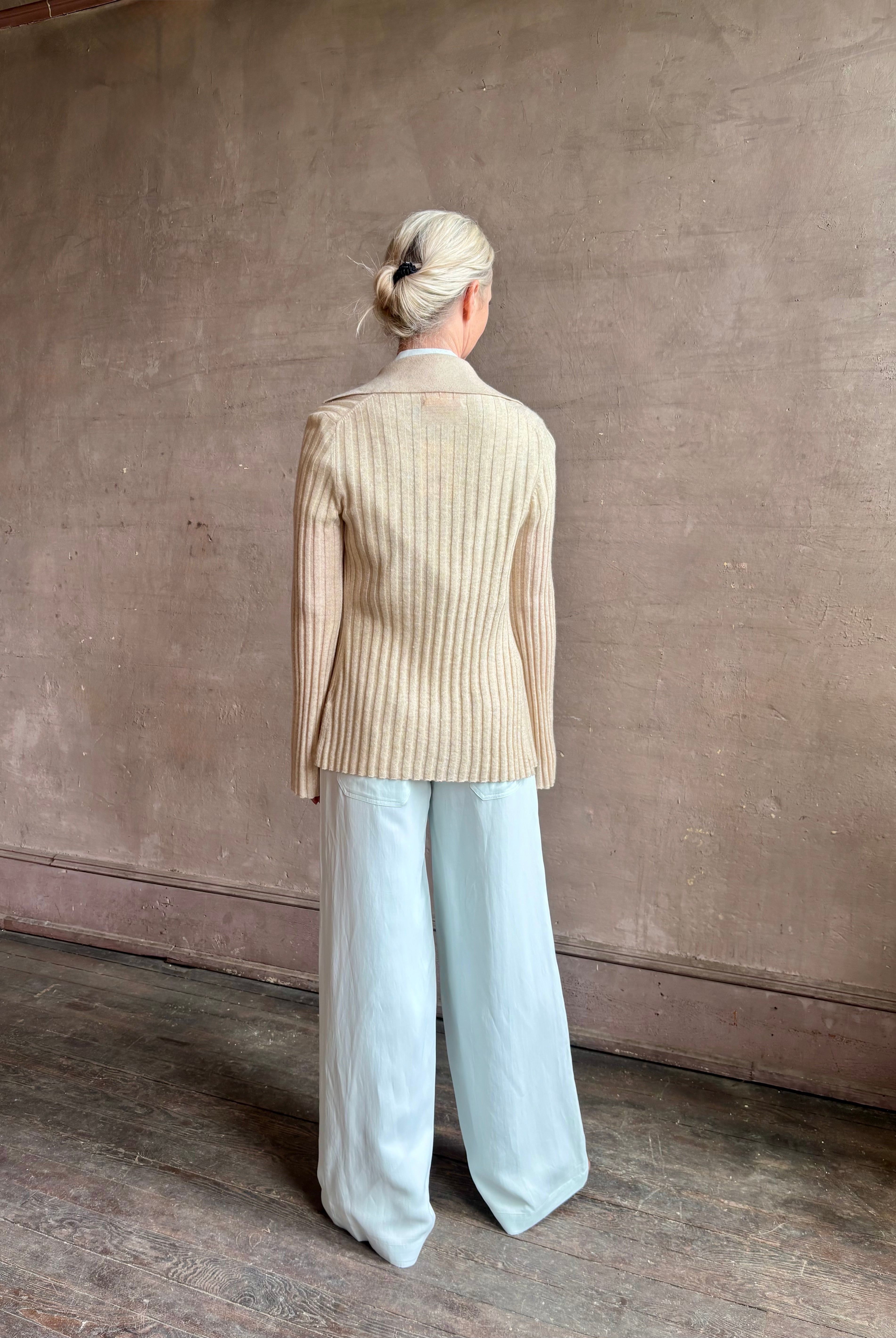 Image of mature woman wearing premium cashmere linen GUEST IN RESIDENCE Breezy Cardigan in Sandstone beige with long sleeves hook and eye front closure and ribbed texture