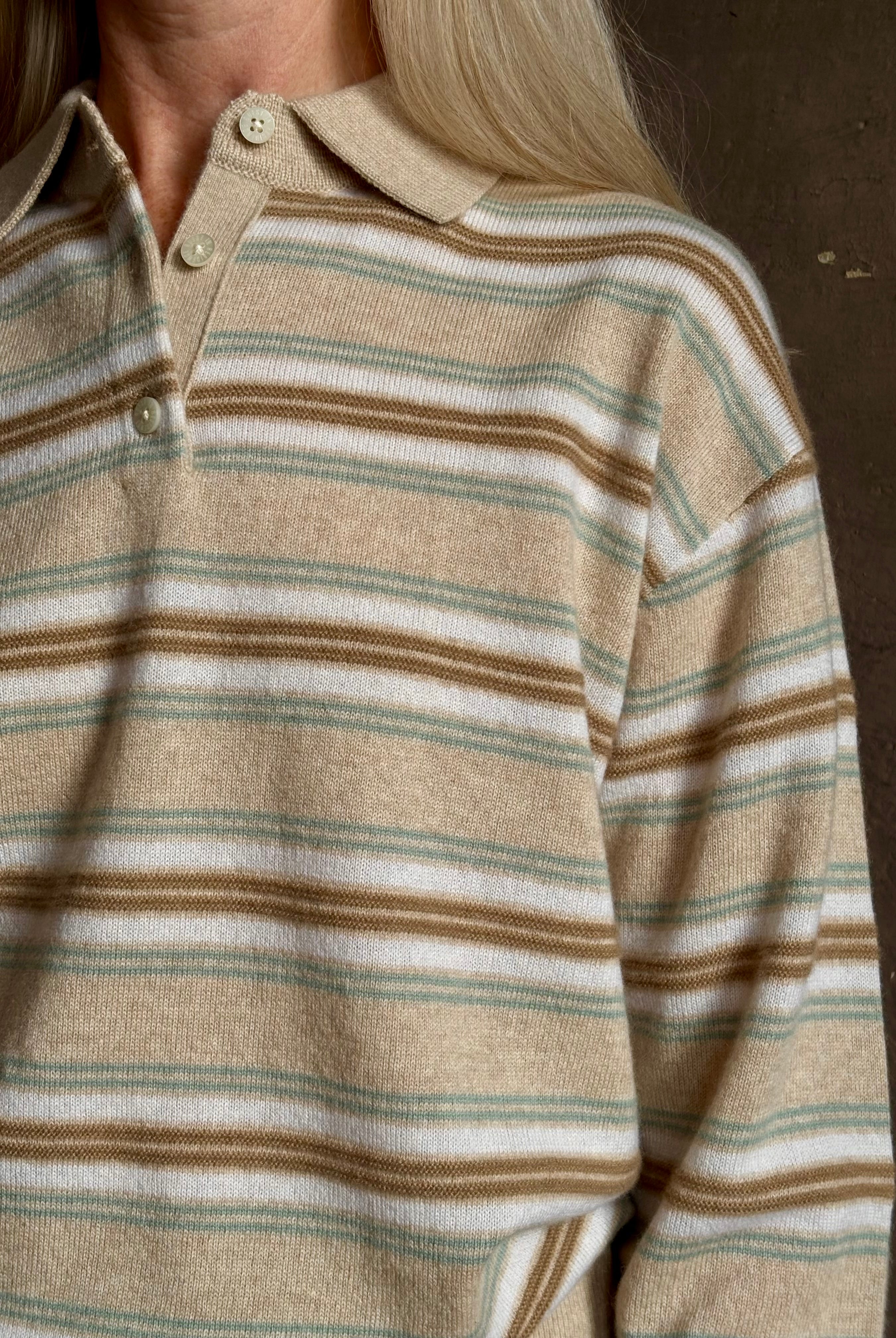 Mature woman wearing Guest in Residence Colliegate beige aqua and white striped cashmere polo sweater