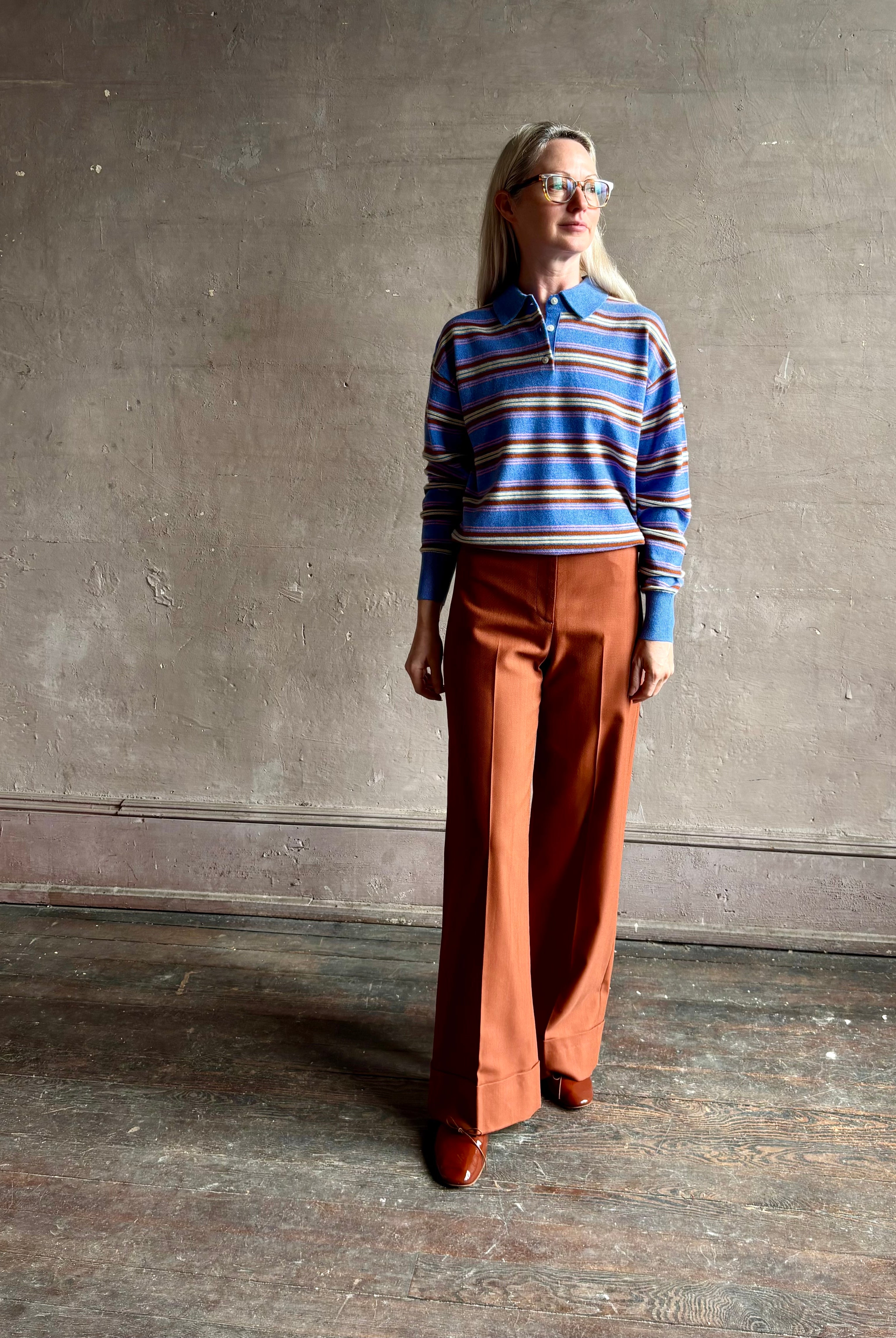 Mature woman wearing luxury women's clothing brand Guest in Residence Colliegate Blue striped polo sweater