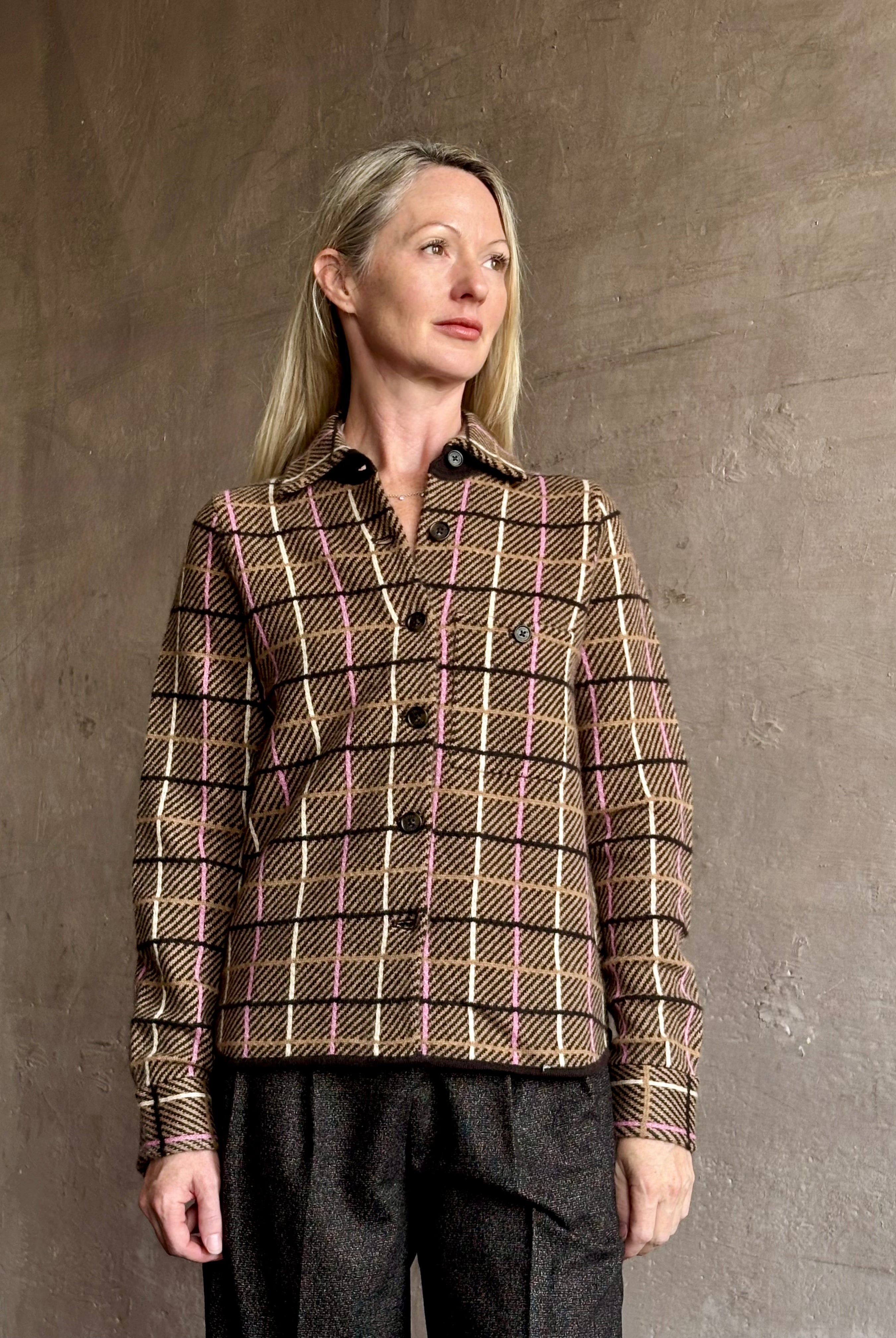 Image of mature woman wearing a sophisticated plaid pattern cashmere shirt with rustic refinement by American luxury brand Guest In Residence