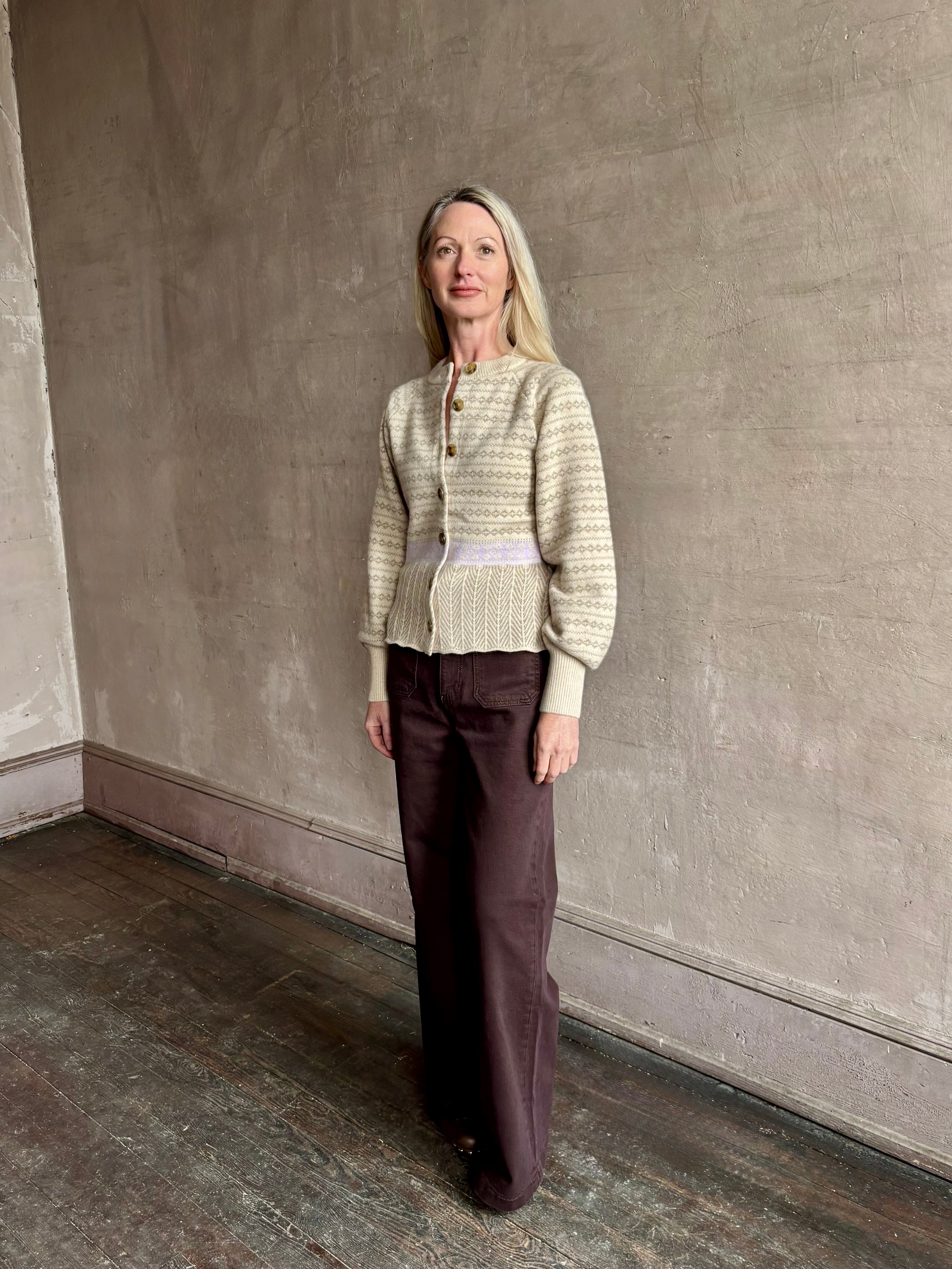 Image of mature woman wearing Guest in Residence Fairisle Cardigan in cream and beige pattern with a subtle lavender knit accent at waistline