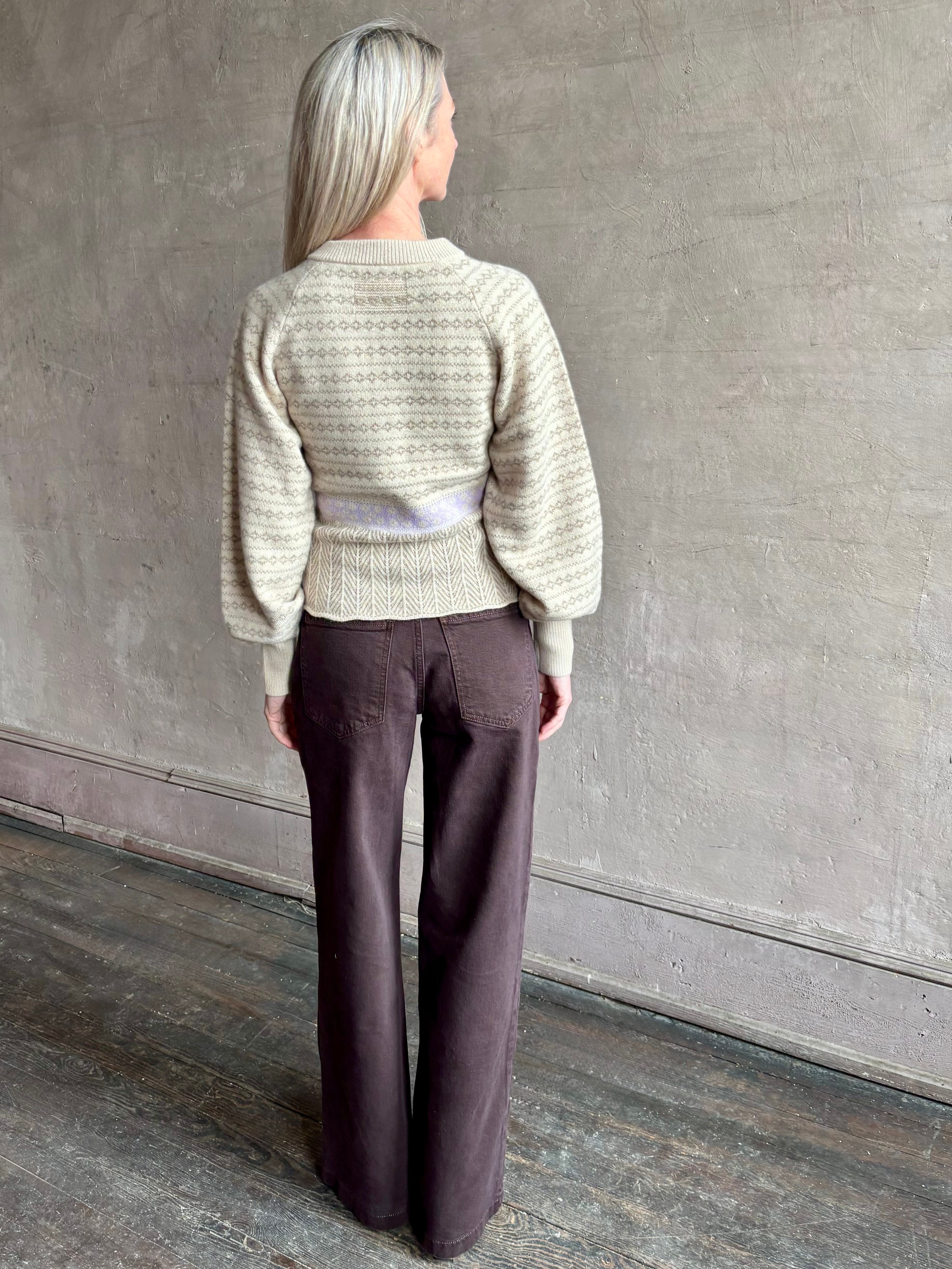 Image of mature woman wearing Guest in Residence Fairisle Cardigan in cream and beige pattern with a subtle lavender knit accent at waistline