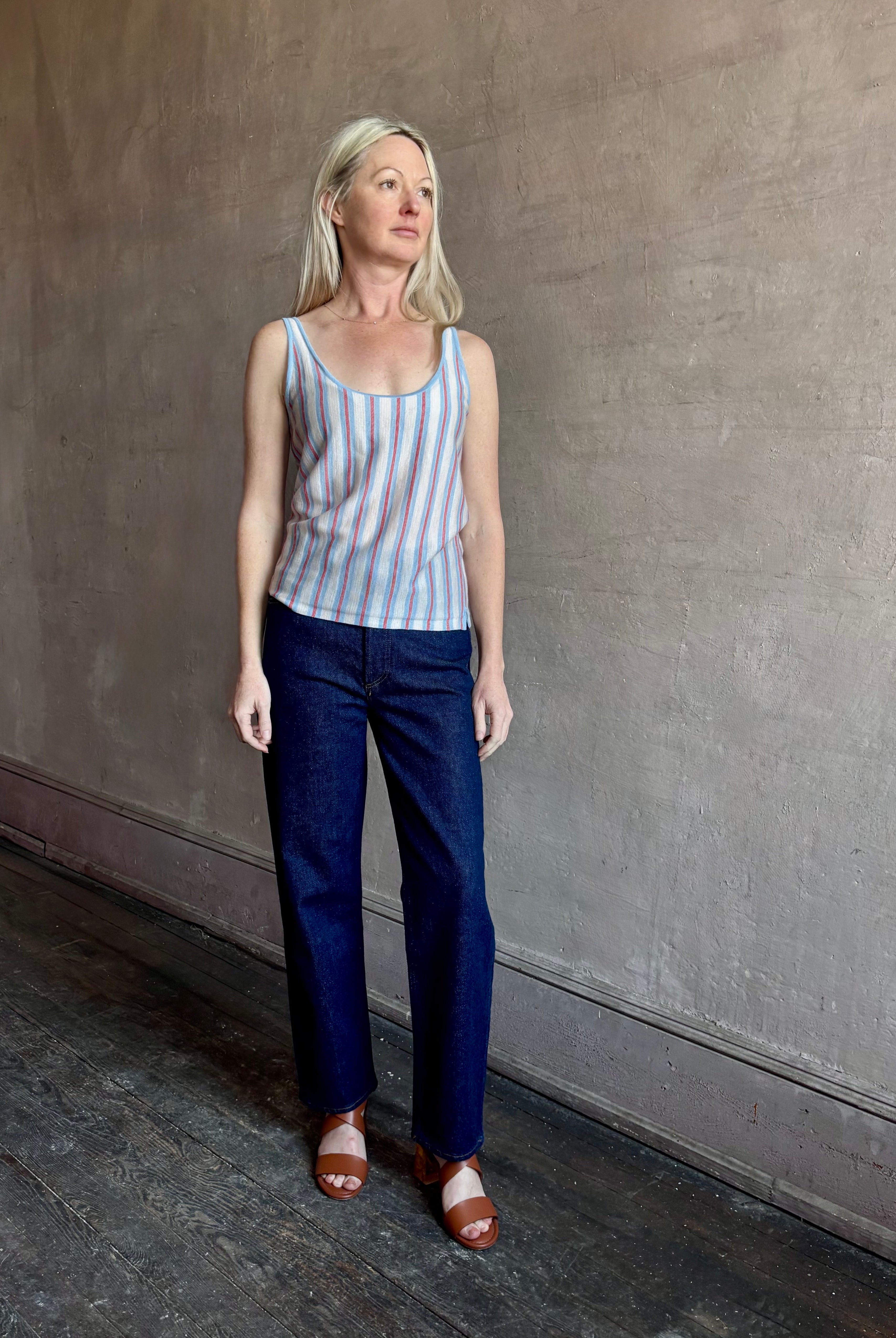 Image of woman wearing lightweight premium Mongolian cashmere GUEST IN RESIDENCE Fine Stripe sleeveless Tank in red and blue stipes with scoop neck