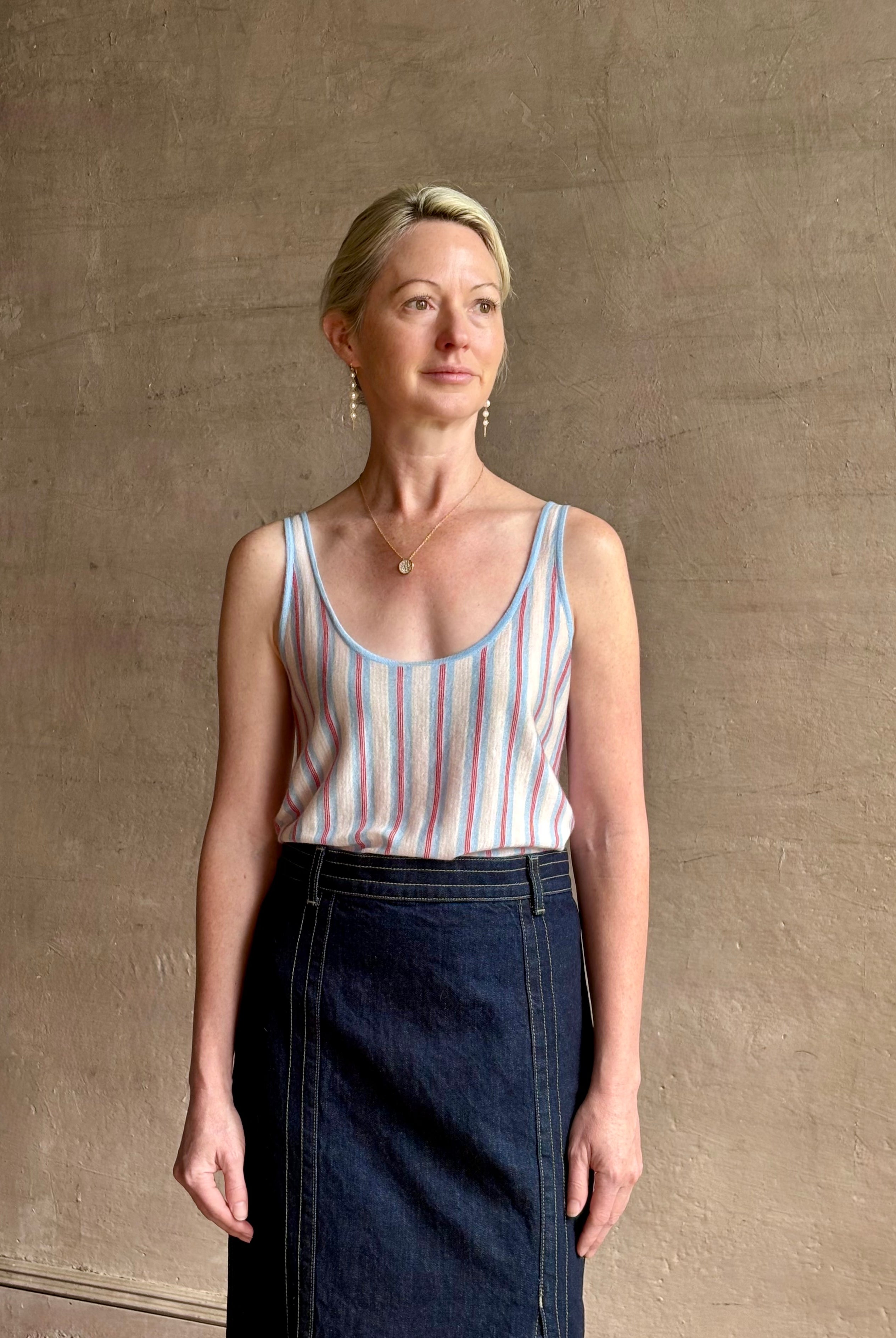 Image of woman wearing lightweight premium Mongolian cashmere GUEST IN RESIDENCE Fine Stripe sleeveless Tank in red and blue stipes with scoop neck