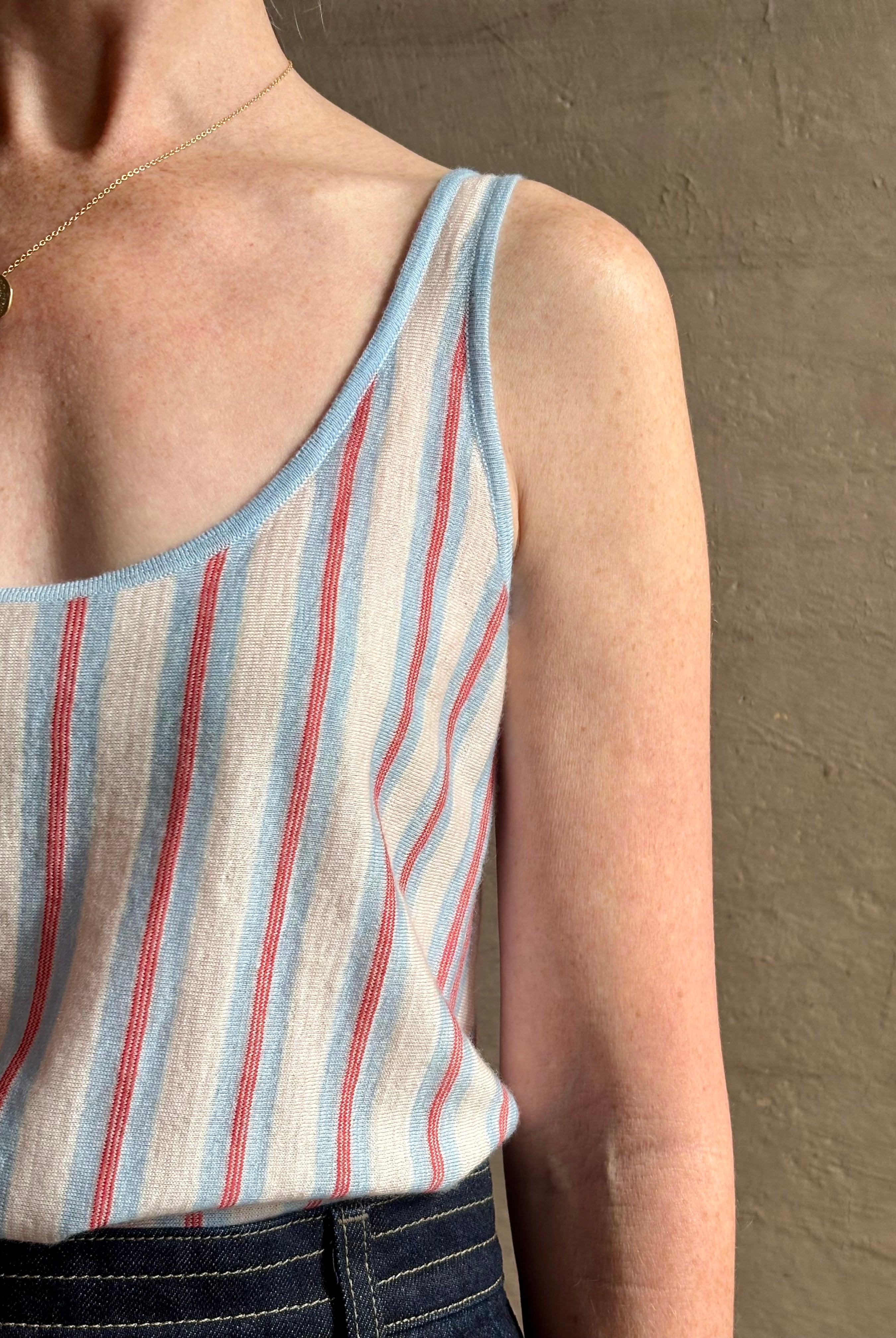 Image of woman wearing lightweight premium Mongolian cashmere GUEST IN RESIDENCE Fine Stripe sleeveless Tank in red and blue stipes with scoop neck