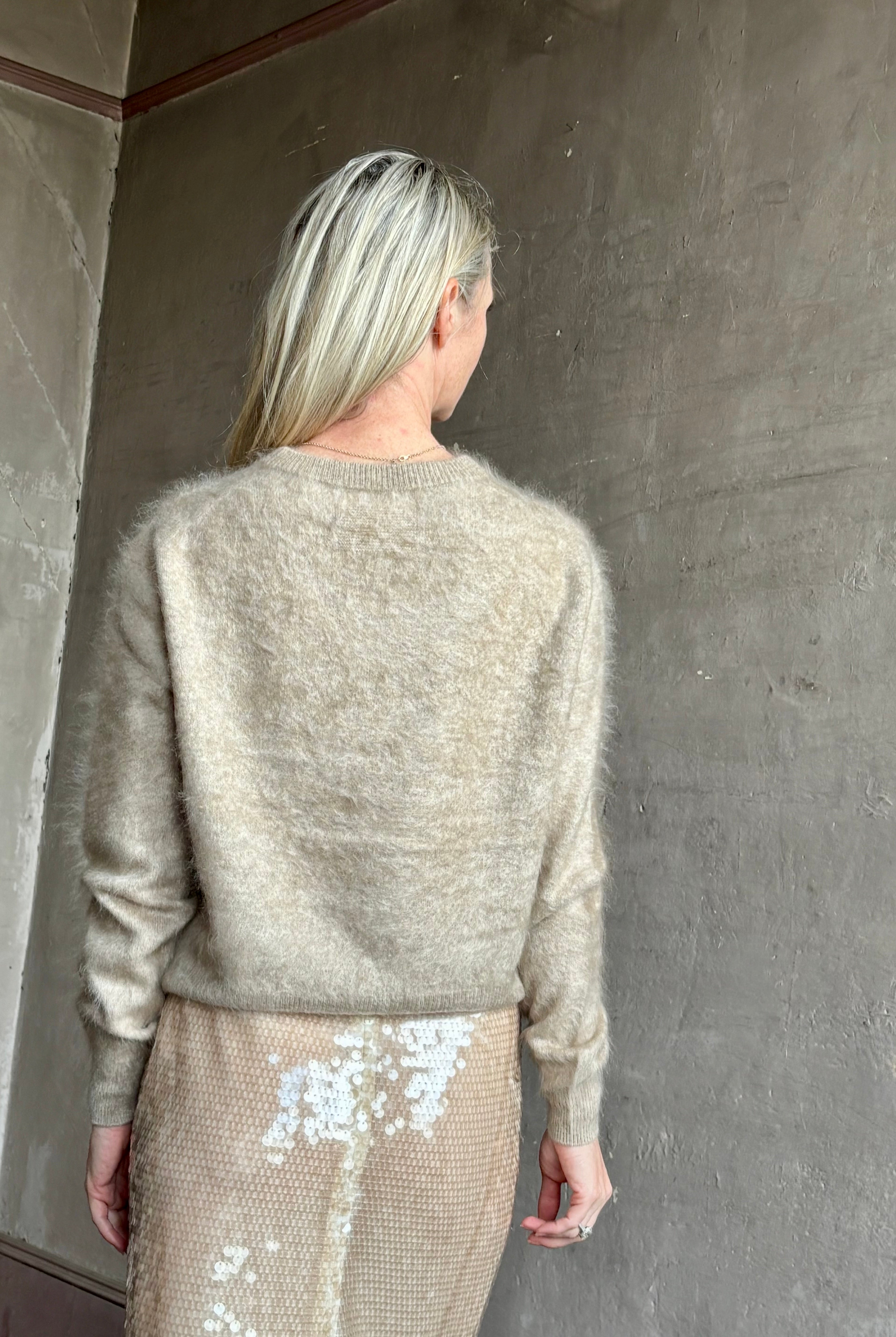 Image of mature model wearing American luxury women's clothing brand Guest In Residence long-sleeve crew neck brushed cashmere beige sweater