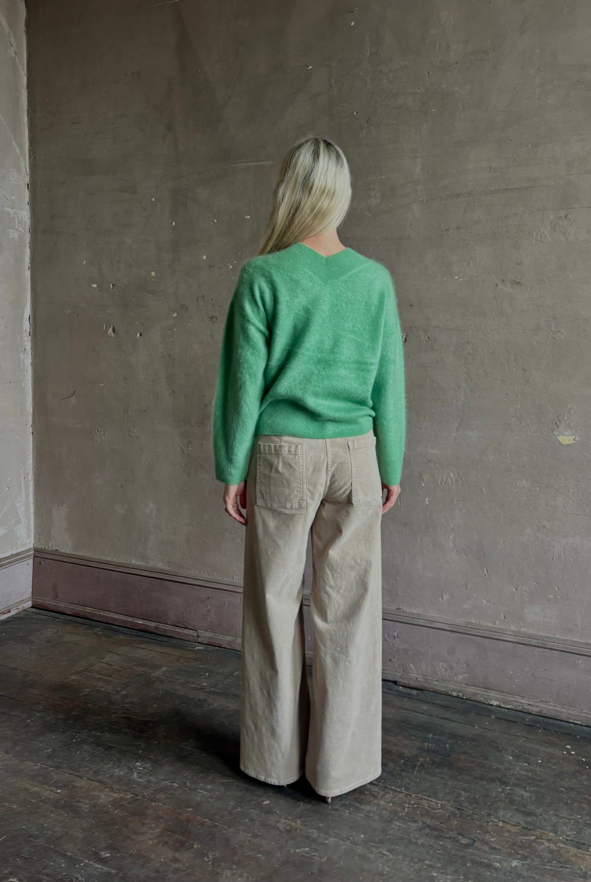 Mature woman wearing Guest in Residence Grizzly Double V Sweater Highland Green brushed cashmere with symmetrical front-and-back V-necklines