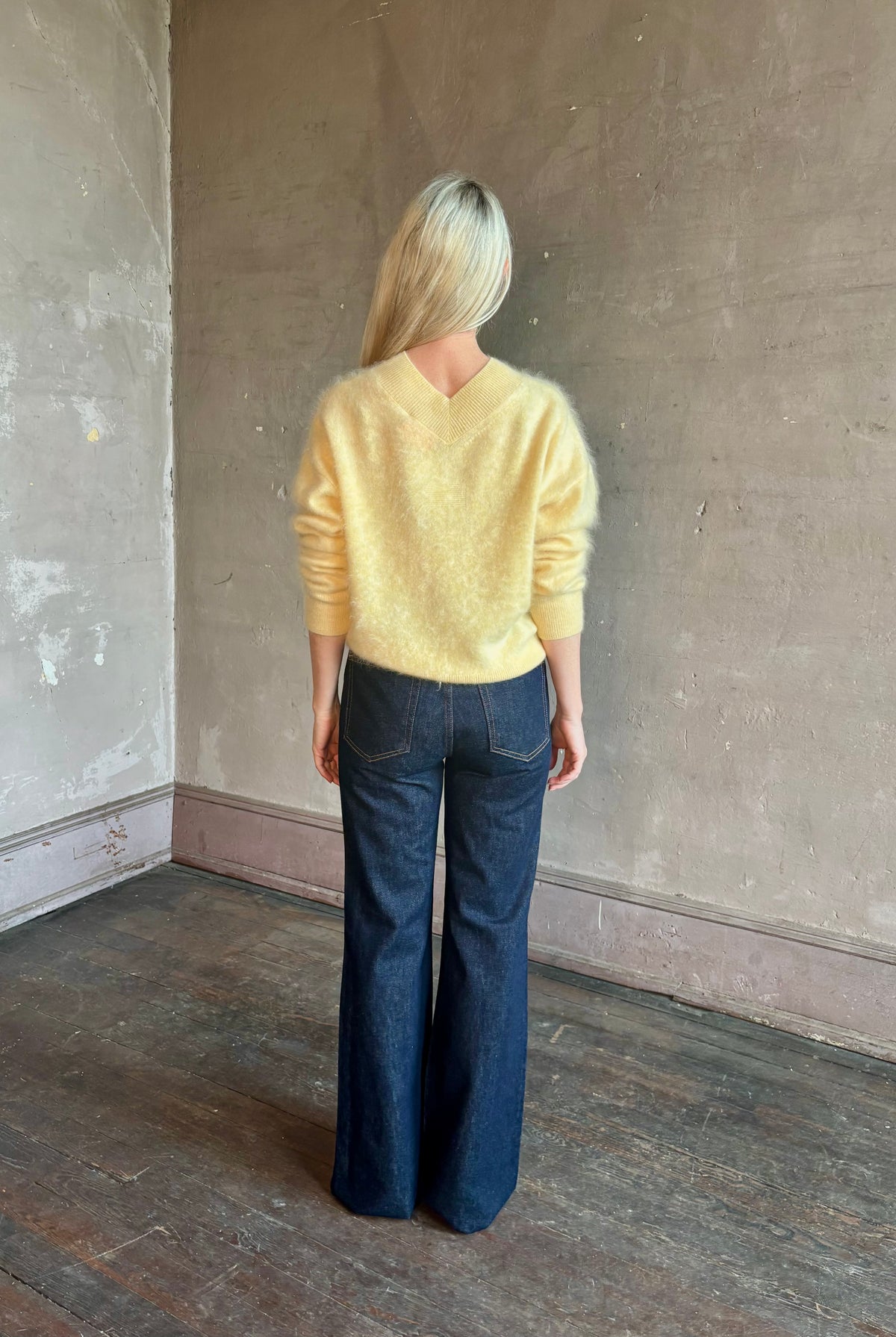 Mature woman wearing Guest in Residence Grizzly Double V Sweater in Butter brushed cashmere front-and-back V-necklines long sleeves