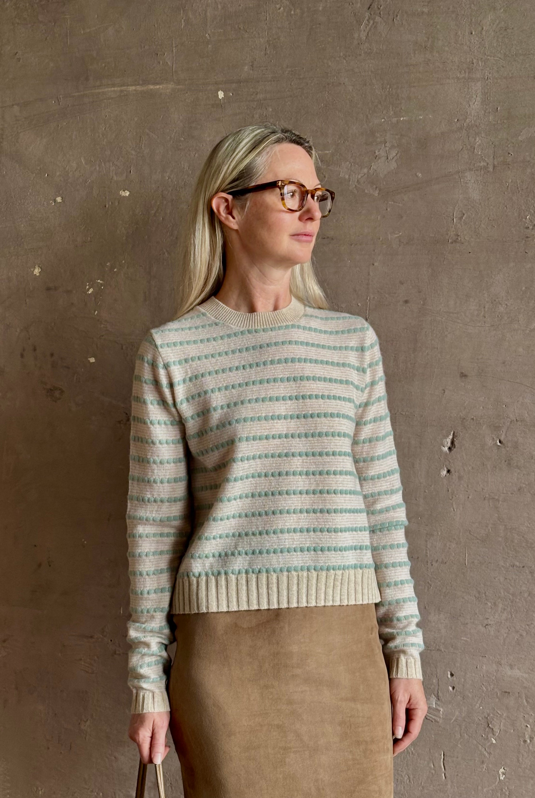 Mature woman wearing Guest in Residence Pebble cream and sage stripe shrunken crew long sleeve cashmere sweater