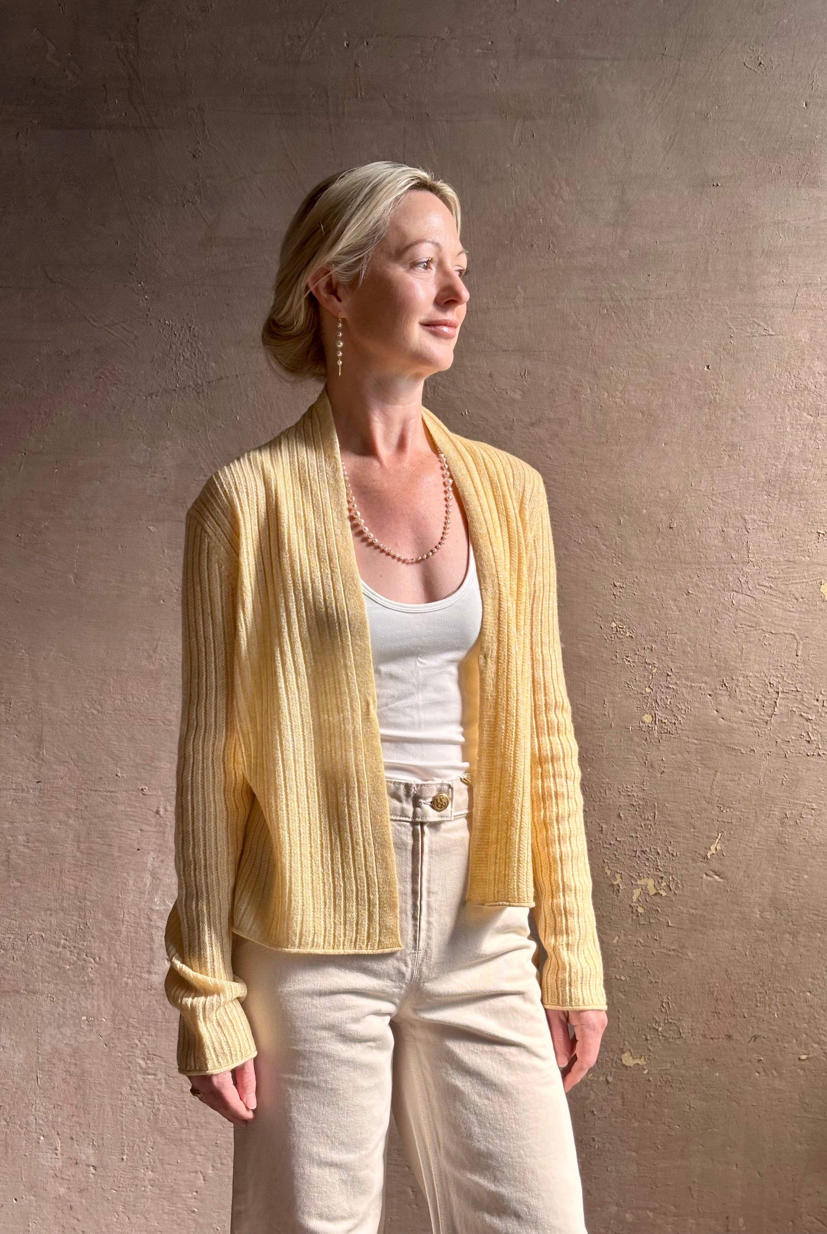 Mature woman wearing Guest in Residence Rib Stealth Cardigan layering essential in butter yellow cashmere linen blend