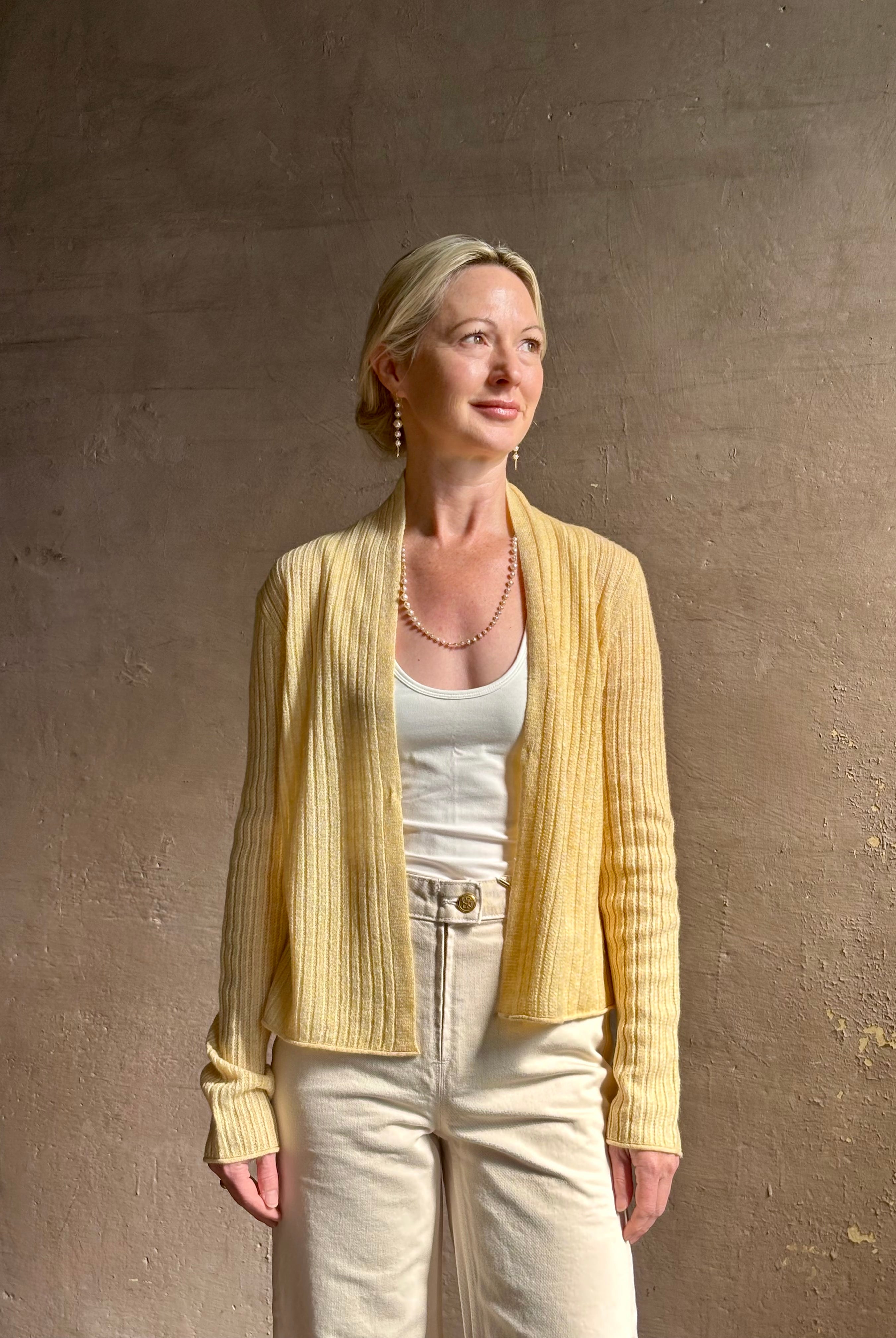 Mature woman wearing Guest in Residence Rib Stealth Cardigan layering essential in butter yellow cashmere linen blend
