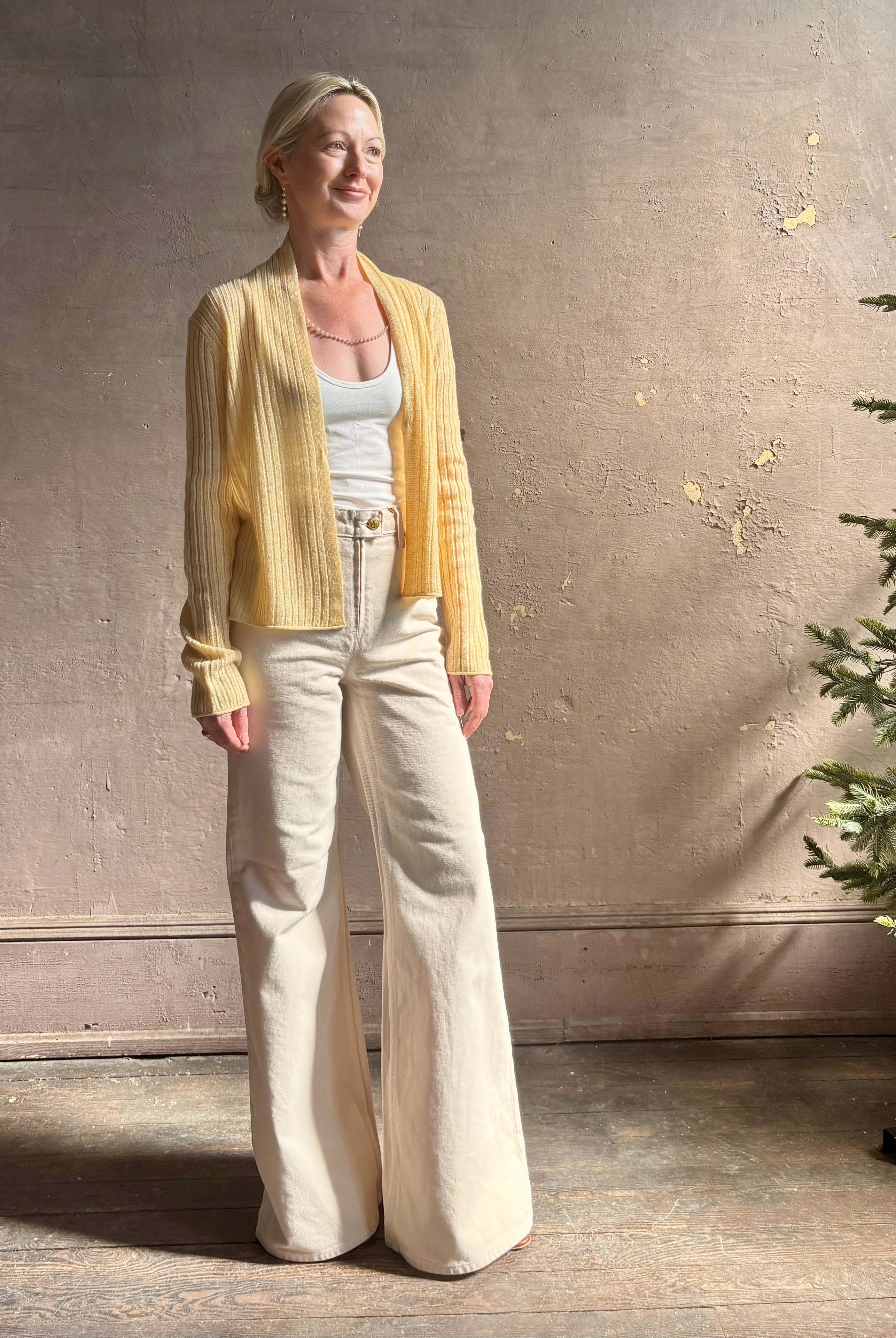 Mature woman wearing Guest in Residence Rib Stealth Cardigan layering essential in butter yellow cashmere linen blend