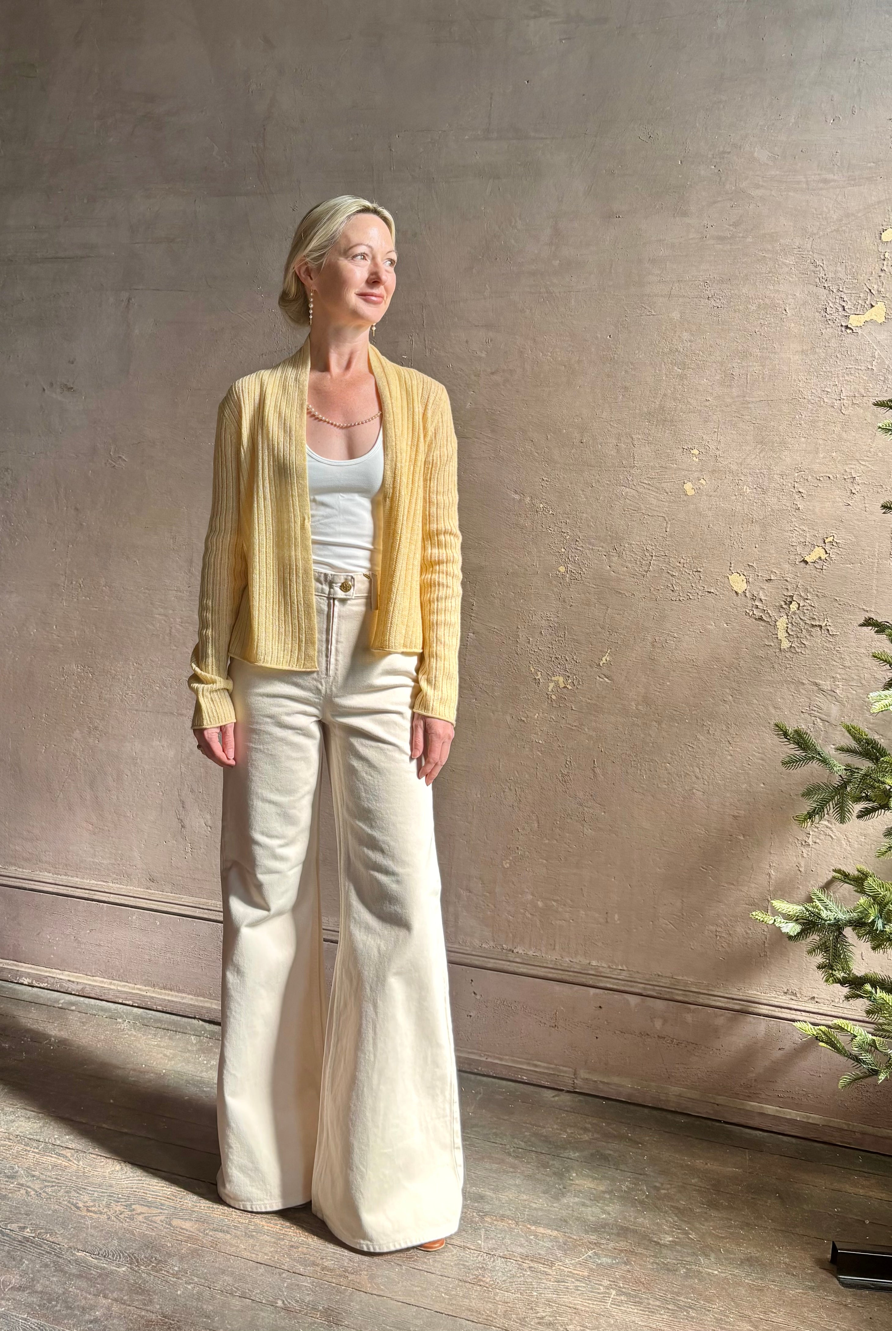 Mature woman wearing Guest in Residence Rib Stealth Cardigan layering essential in butter yellow cashmere linen blend