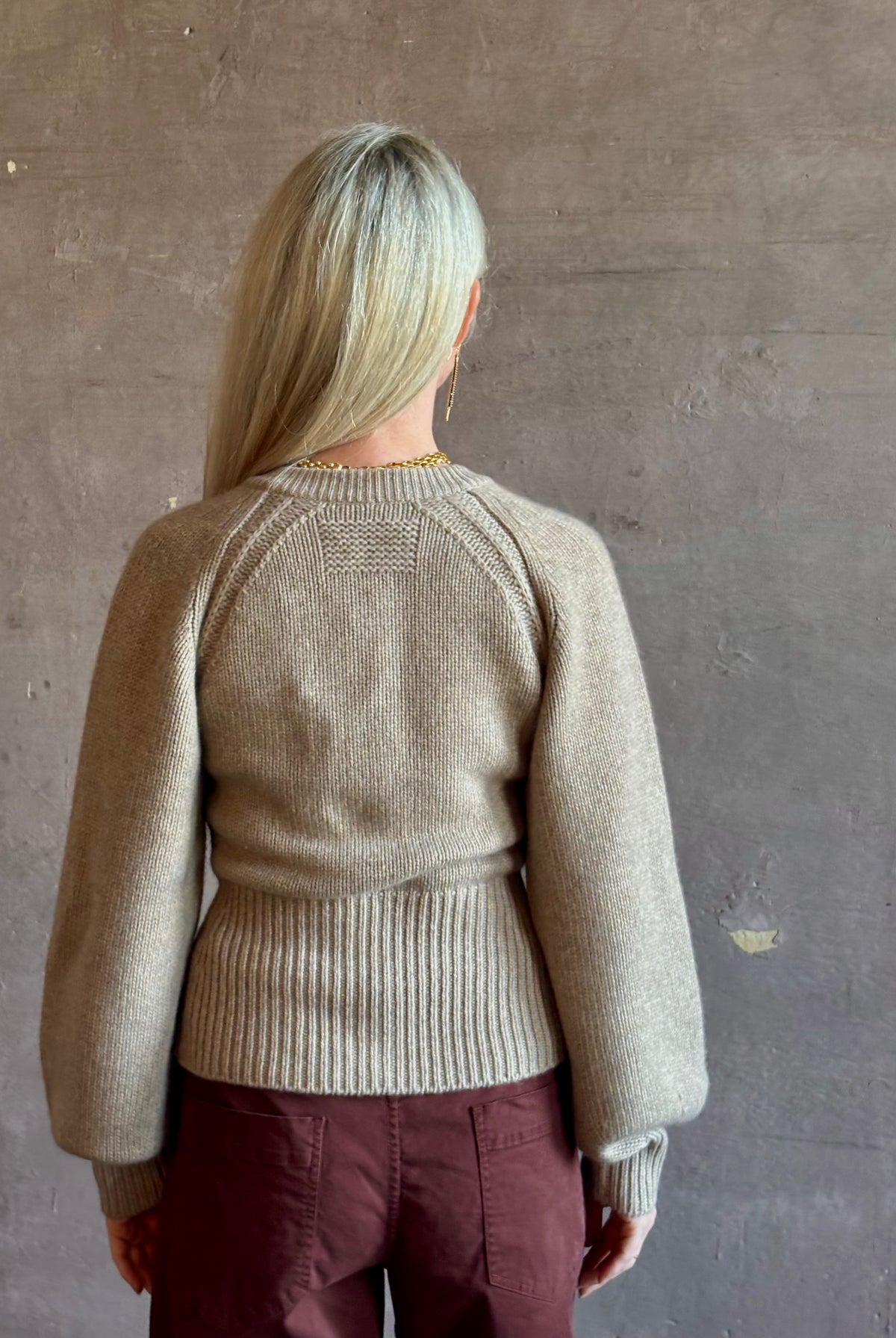 Mature woman wearing Guest in Residence Sculpted Cardigan in Taupe medium gauge cashmere raglan sleeves button front fitted waist softly structured