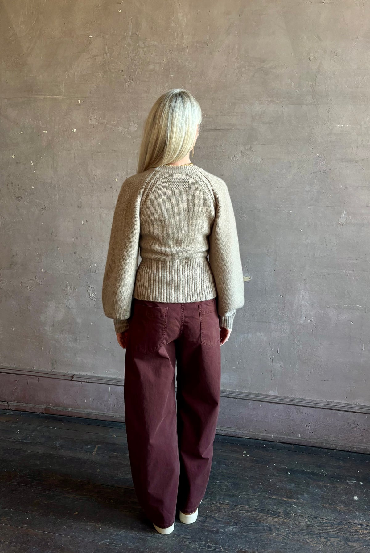 Mature woman wearing Guest in Residence Sculpted Cardigan in Taupe medium gauge cashmere raglan sleeves button front fitted waist softly structured