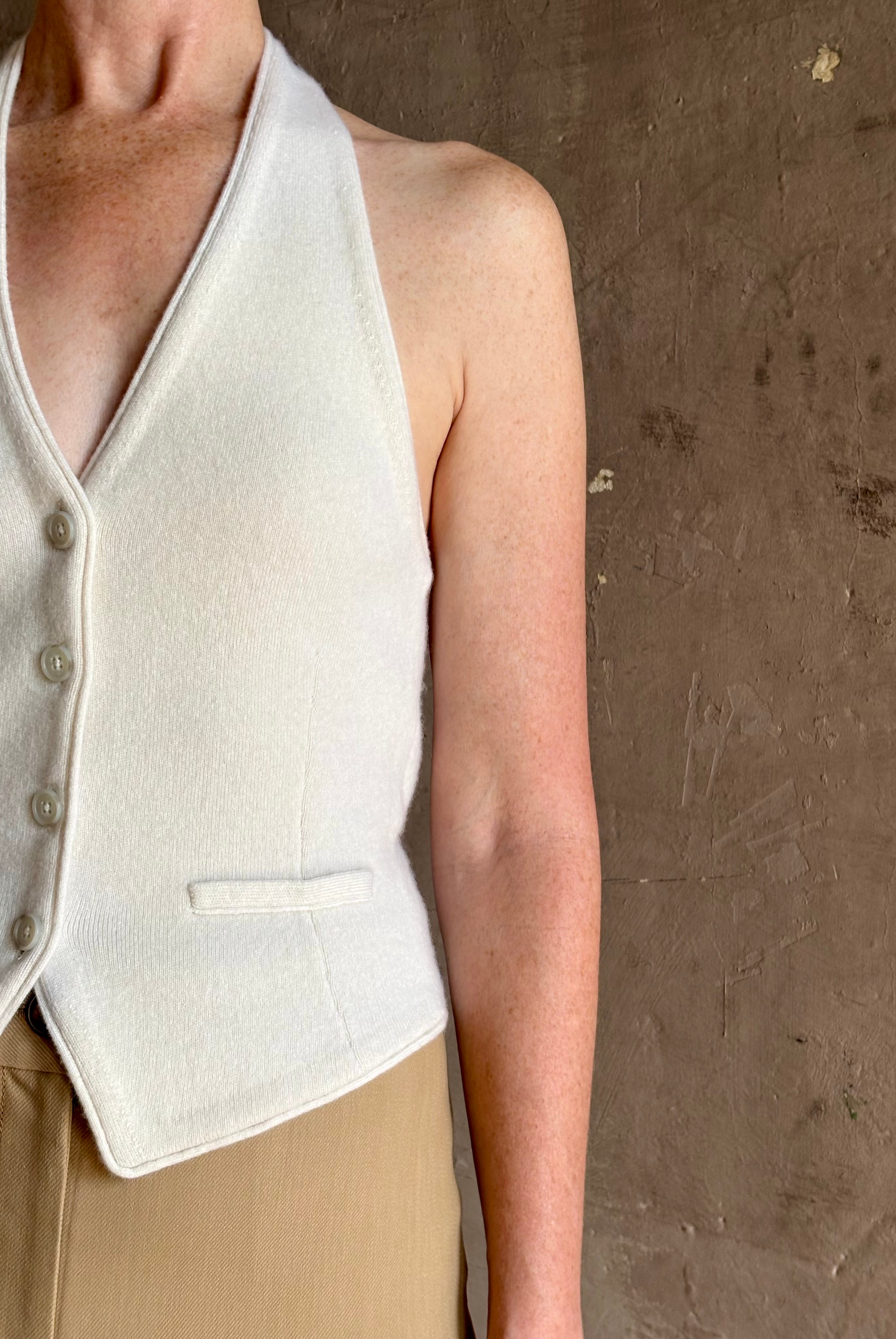 Mature woman wearing Guest in Residence premium cashmere halter top vest expert tailoring white sleeveless
