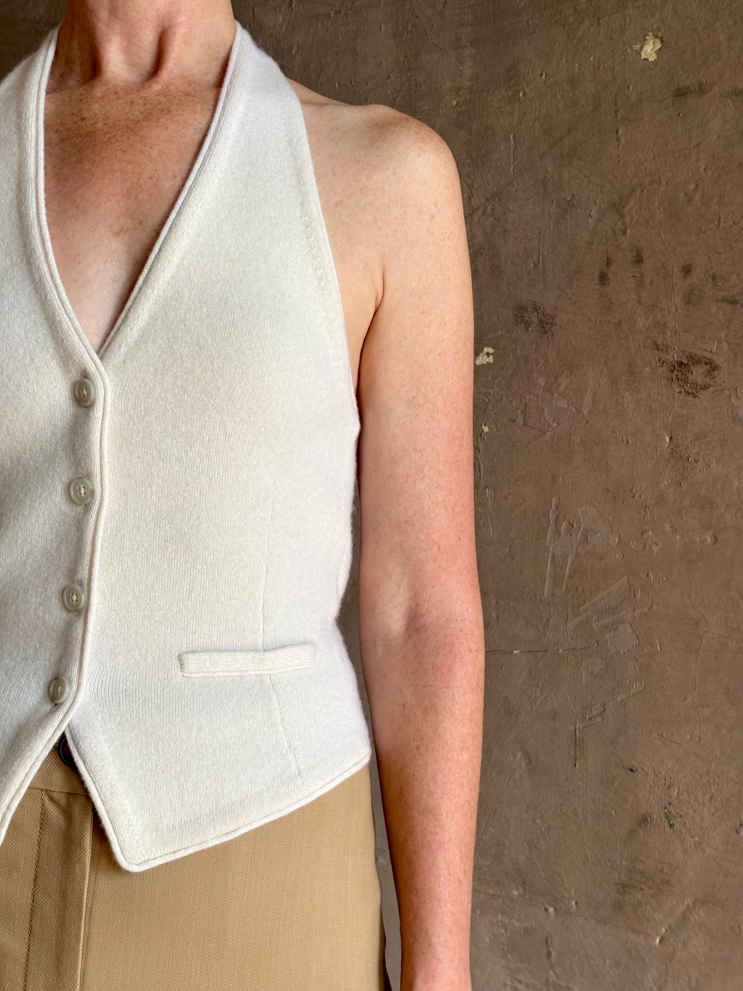 Mature woman wearing Guest in Residence premium cashmere halter top vest expert tailoring white sleeveless