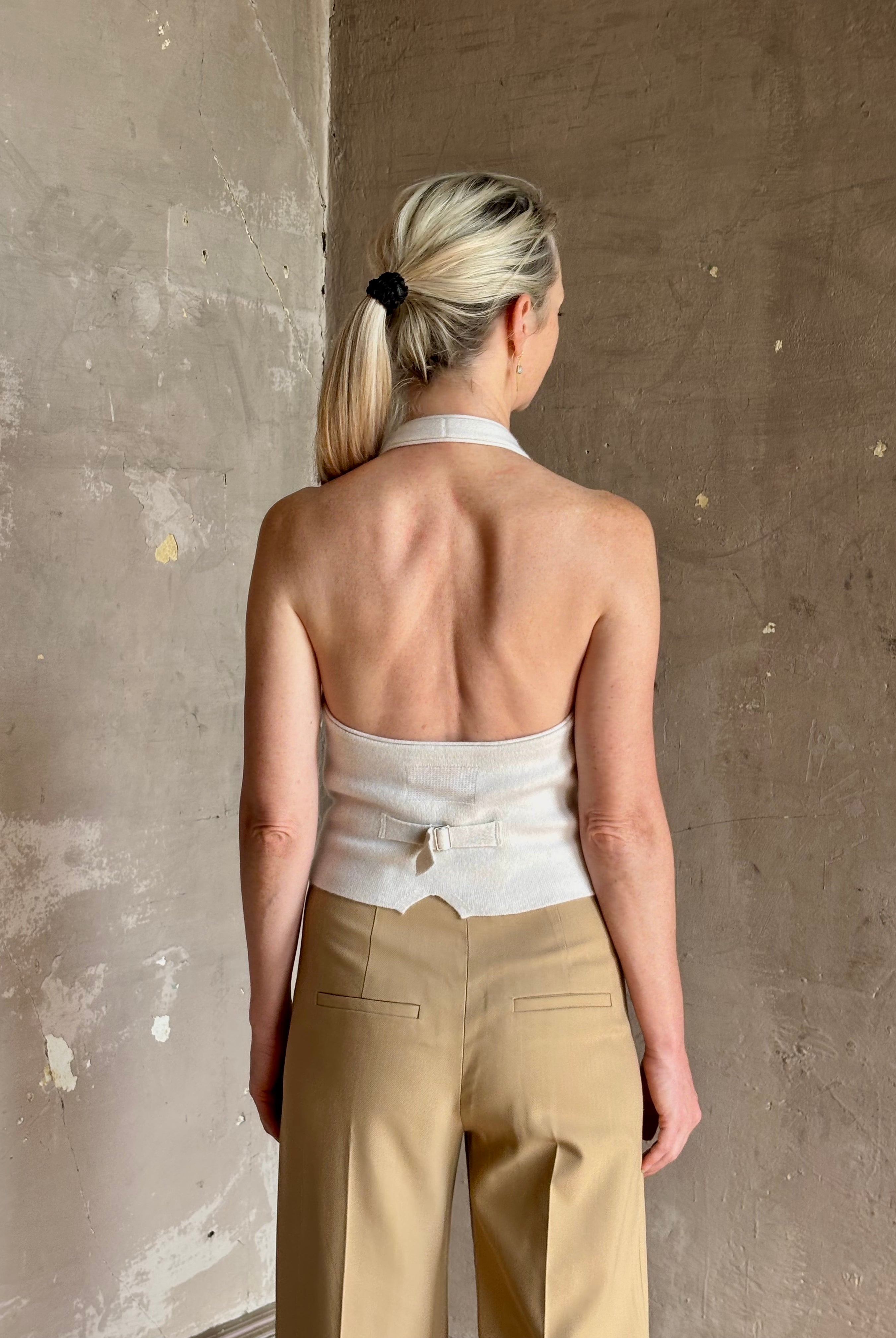 Mature woman wearing Guest in Residence premium cashmere halter top backless white expert tailoring