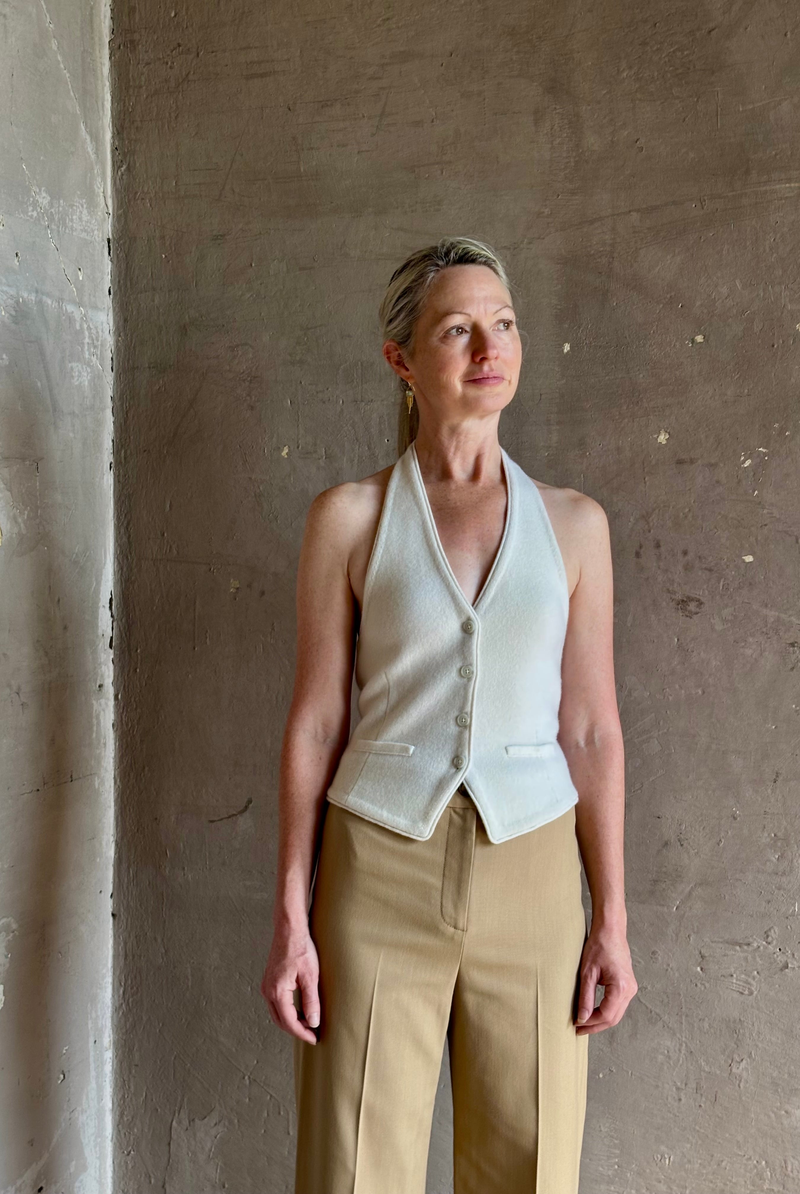 Mature woman wearing Guest in Residence premium cashmere halter top vest with expert tailoring v-neck