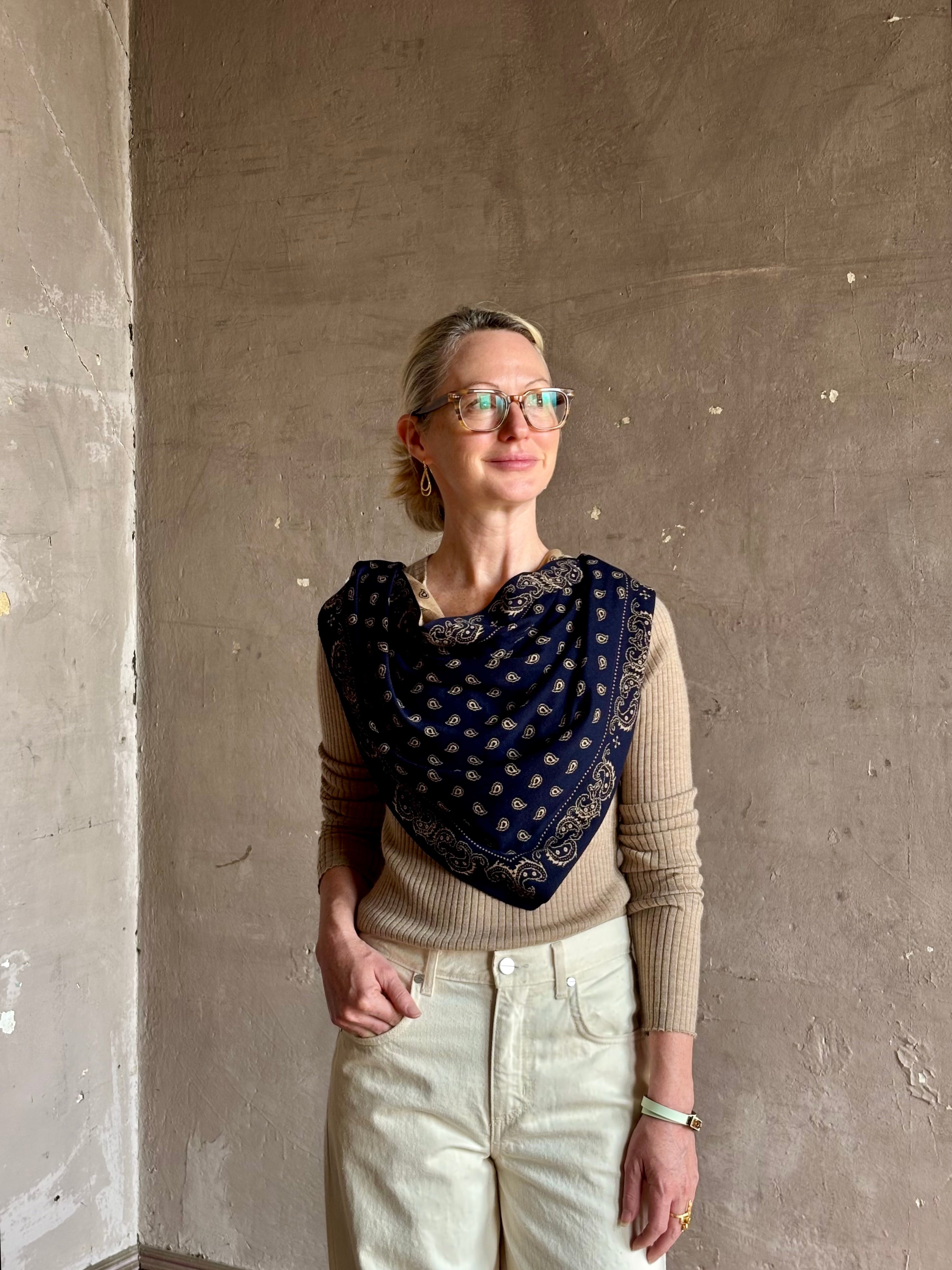 Mature woman wearing Guest in Residence The Wild Rag navy blue patterned bandana triangle reversible scarf