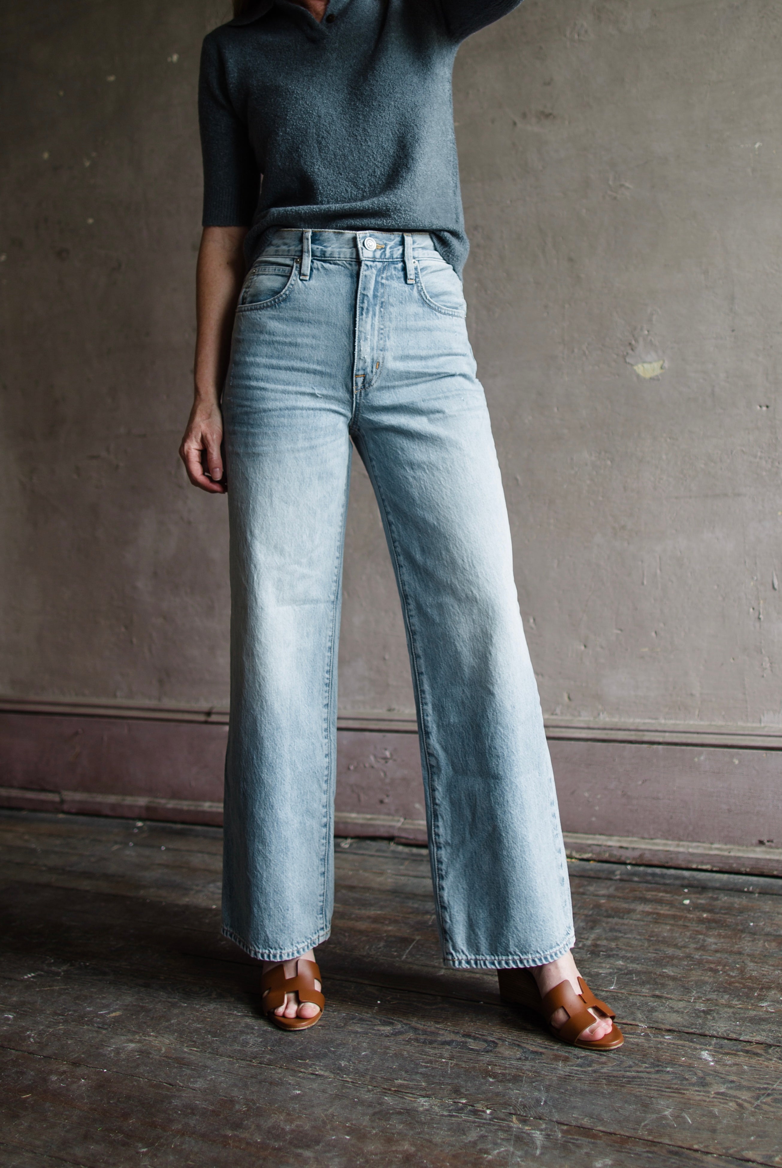Image featuring a woman wearing the Grace Ankle jeans by Slvrlake with a high rise, wide leg and an ankle length fit in heartache wash.
