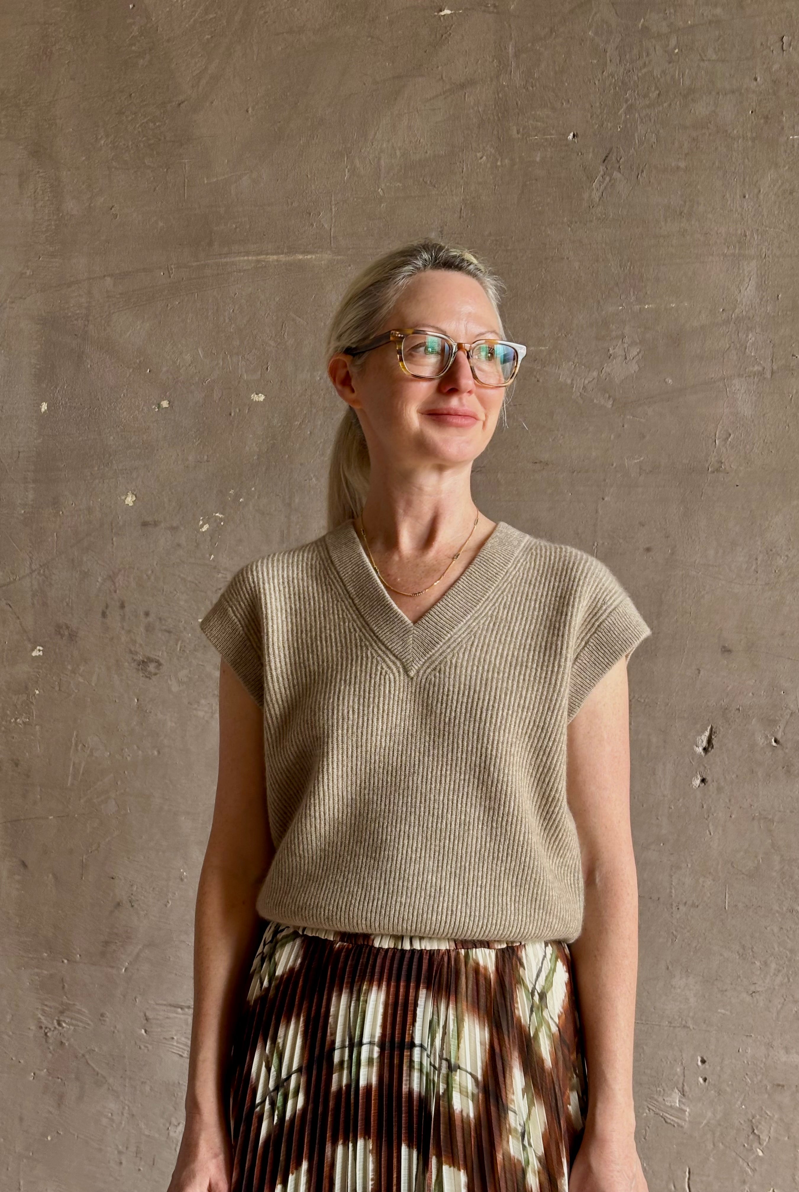 Mature woman wearing Guest in Residence taupe Ribbed sweater with v-neck luxury Mongolian cashmere sleeveless