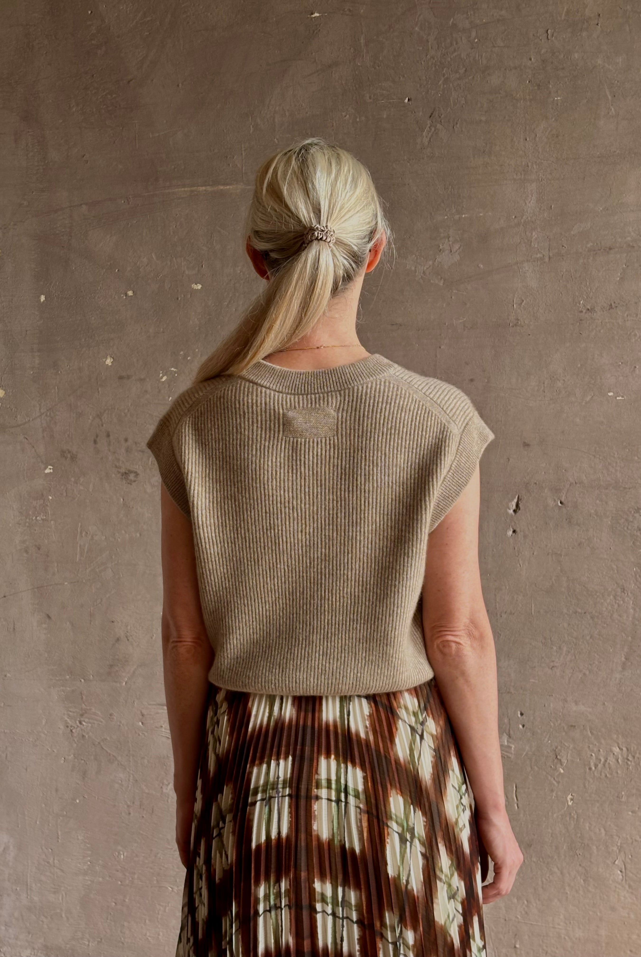 Mature woman wearing Guest in Residence taupe Ribbed sweater with v-neck luxury Mongolian cashmere sleeveless