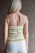 Model wearing premium designer Guest in Residence Plaid Tank top in butter yellow with taupe and white plaid pattern in lightweight silk linen blend