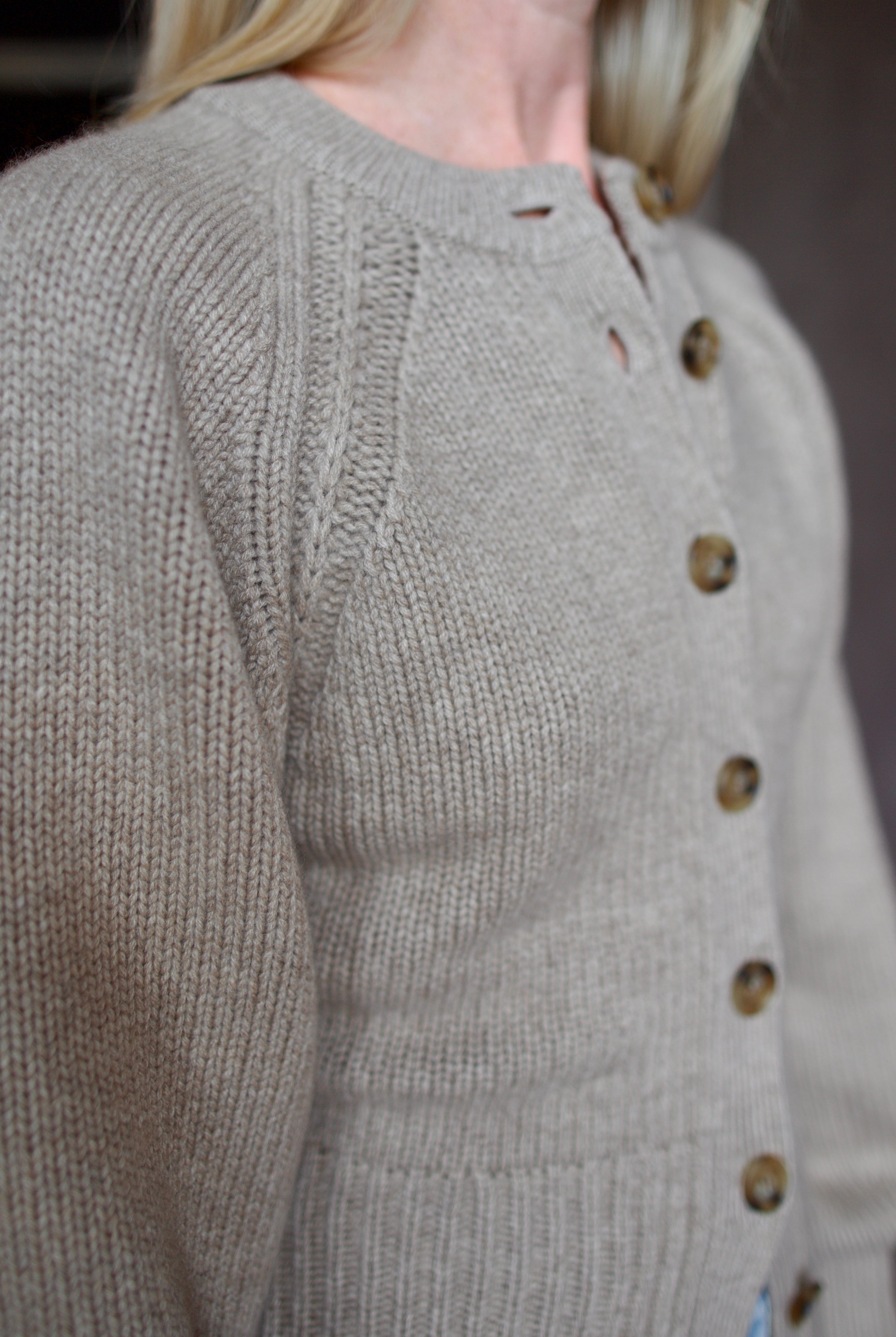 Close up of beige Guest in Residence cashmere cardigan with Slvrlake denim