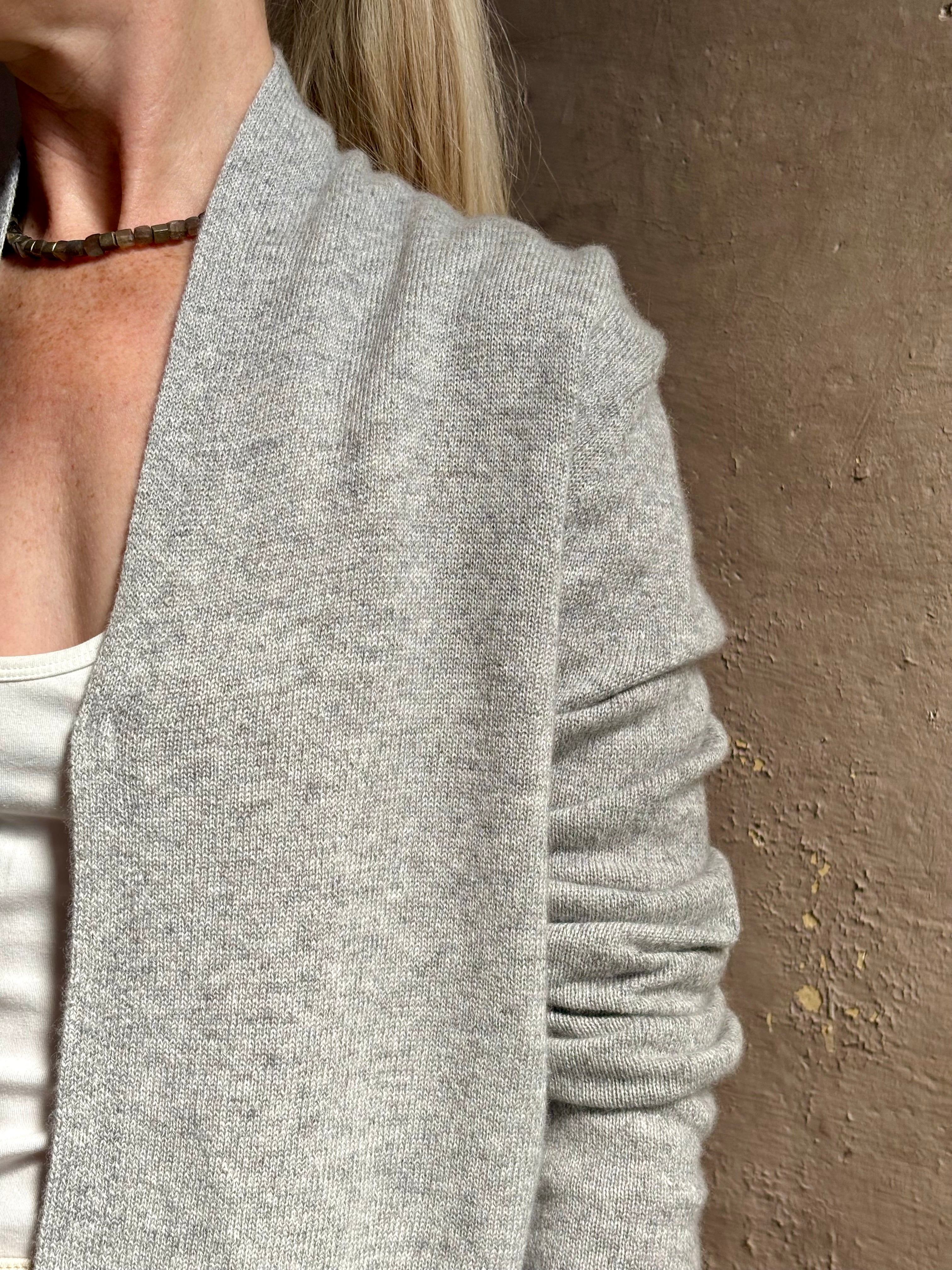 Mature woman wearing comfortable stone grey cashmere linen GUEST IN RESIDENCE Stealth long sleeve crop Cardigan with single hook and eye front closure crafted in a neutral stone grey