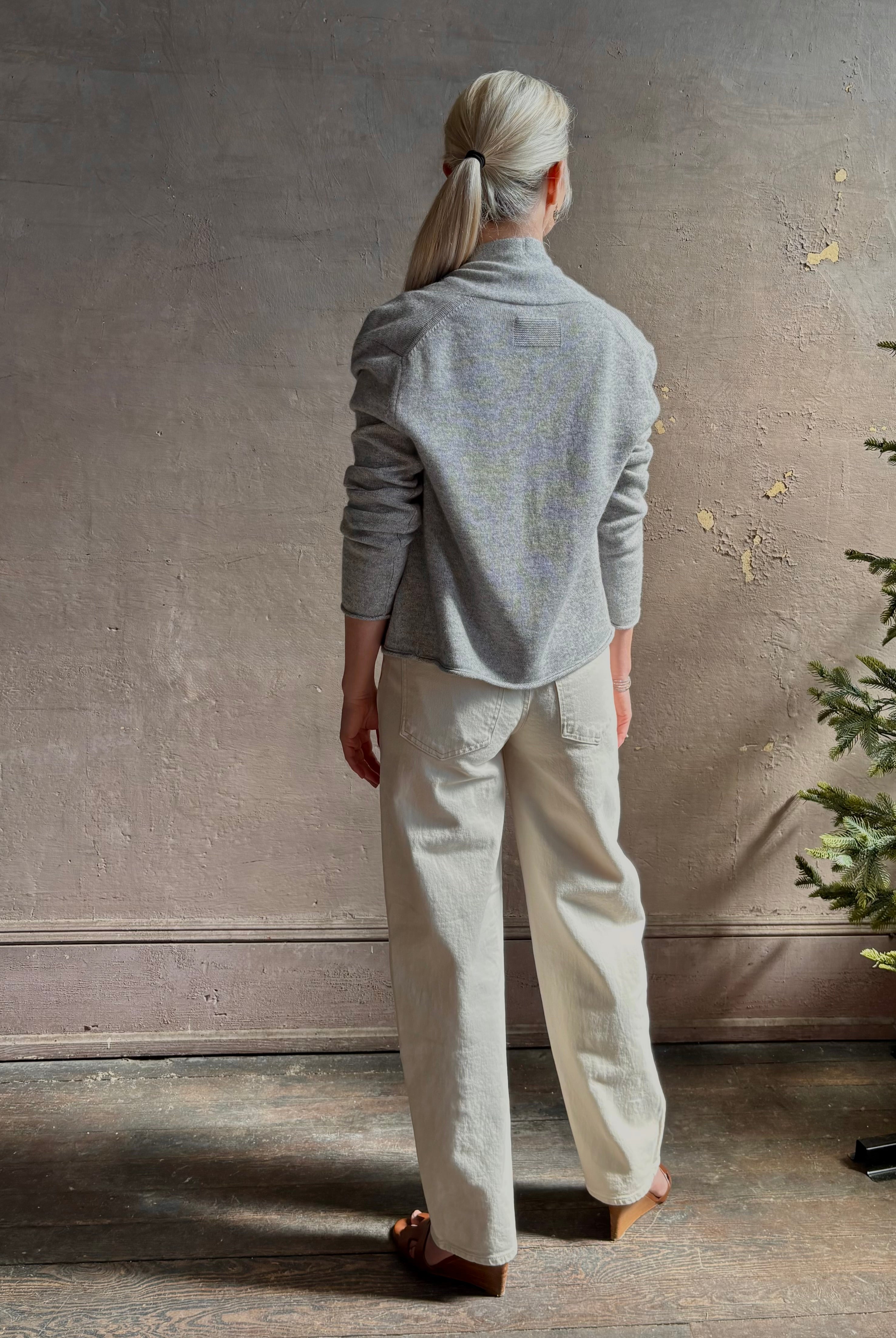 Mature woman wearing comfortable stone grey cashmere linen GUEST IN RESIDENCE Stealth long sleeve crop Cardigan with single hook and eye front closure crafted in a neutral stone grey
