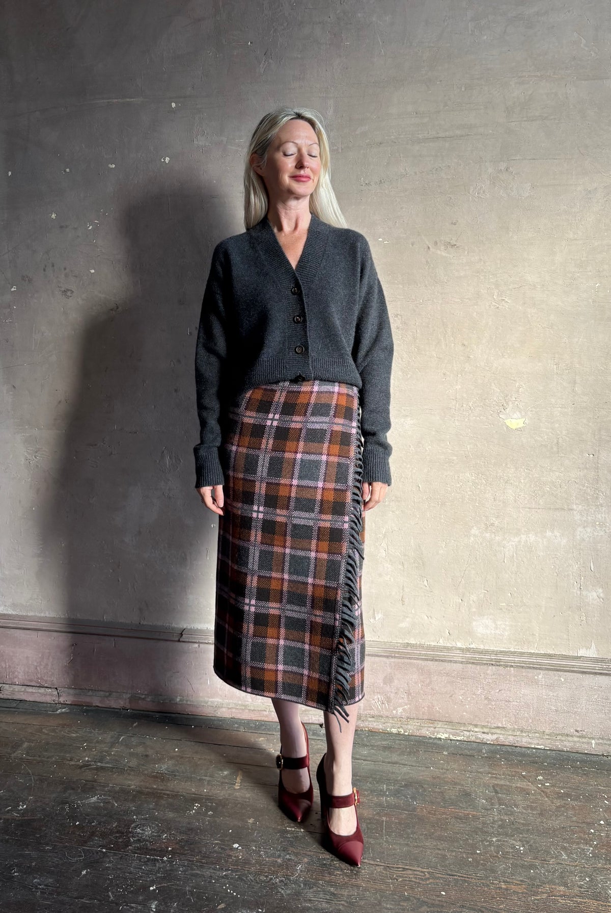 Mature woman wearing Guest in Residence Tartan Wrap Skirt in Sprinkle Combo wool-cashmere midi pencil silhouette and fringe trim