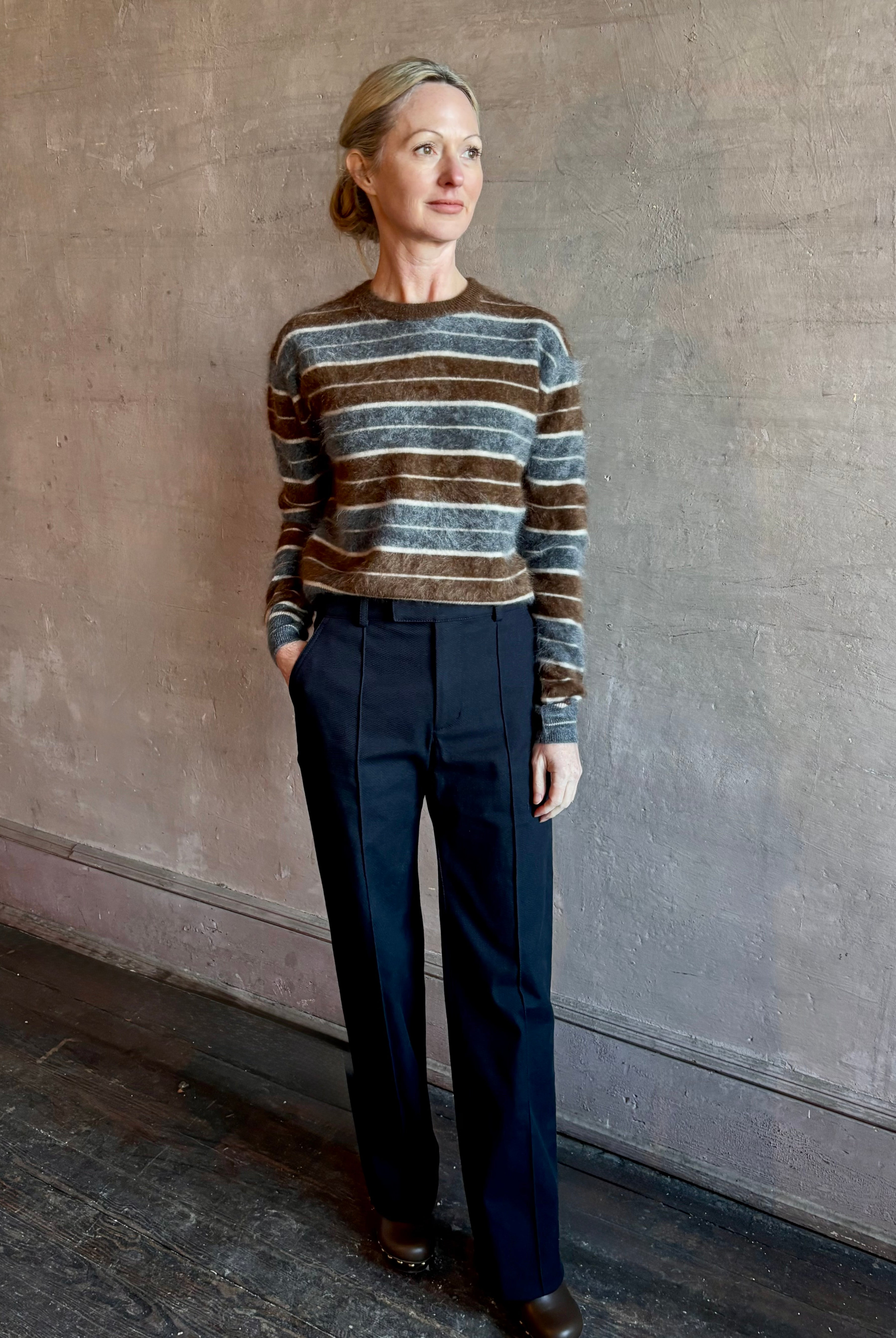 Image of woman wearing premium brushed cashmere crew neck sweater from Guest in Residence in brown and charcoal grey stripe