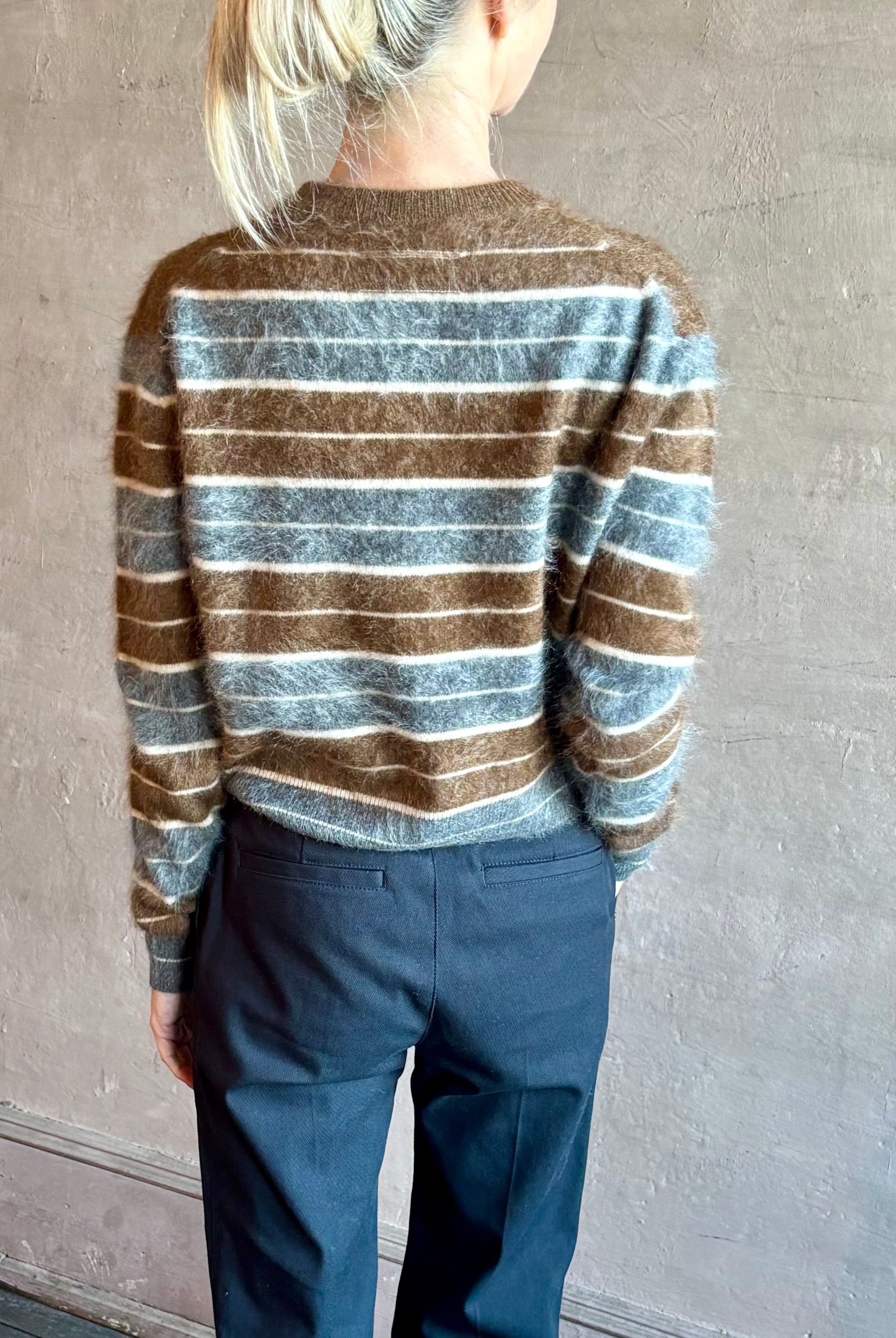 Image of woman wearing premium brushed cashmere crew neck sweater from Guest in Residence in brown and charcoal grey stripe
