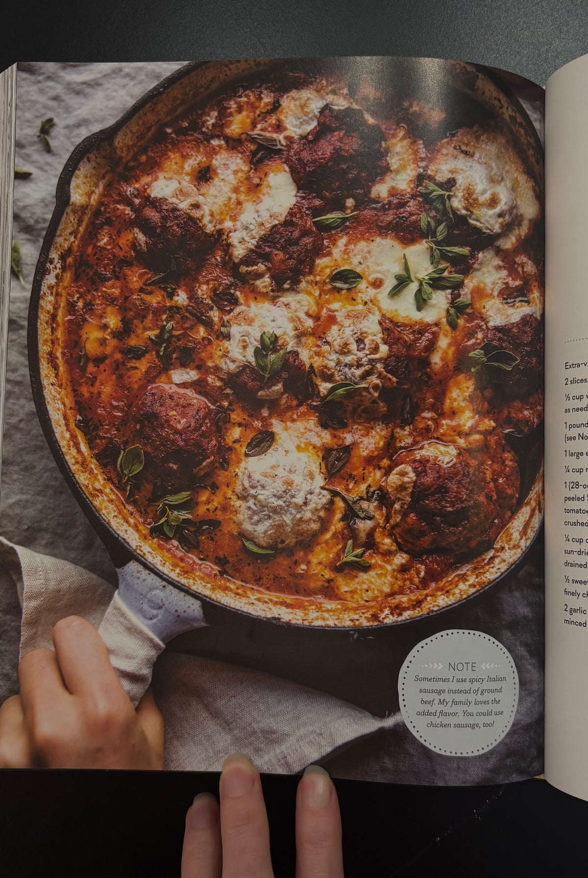 An open half baked harvest cookbook spread showing a large recipe page with a photo of a skillet pasta dish